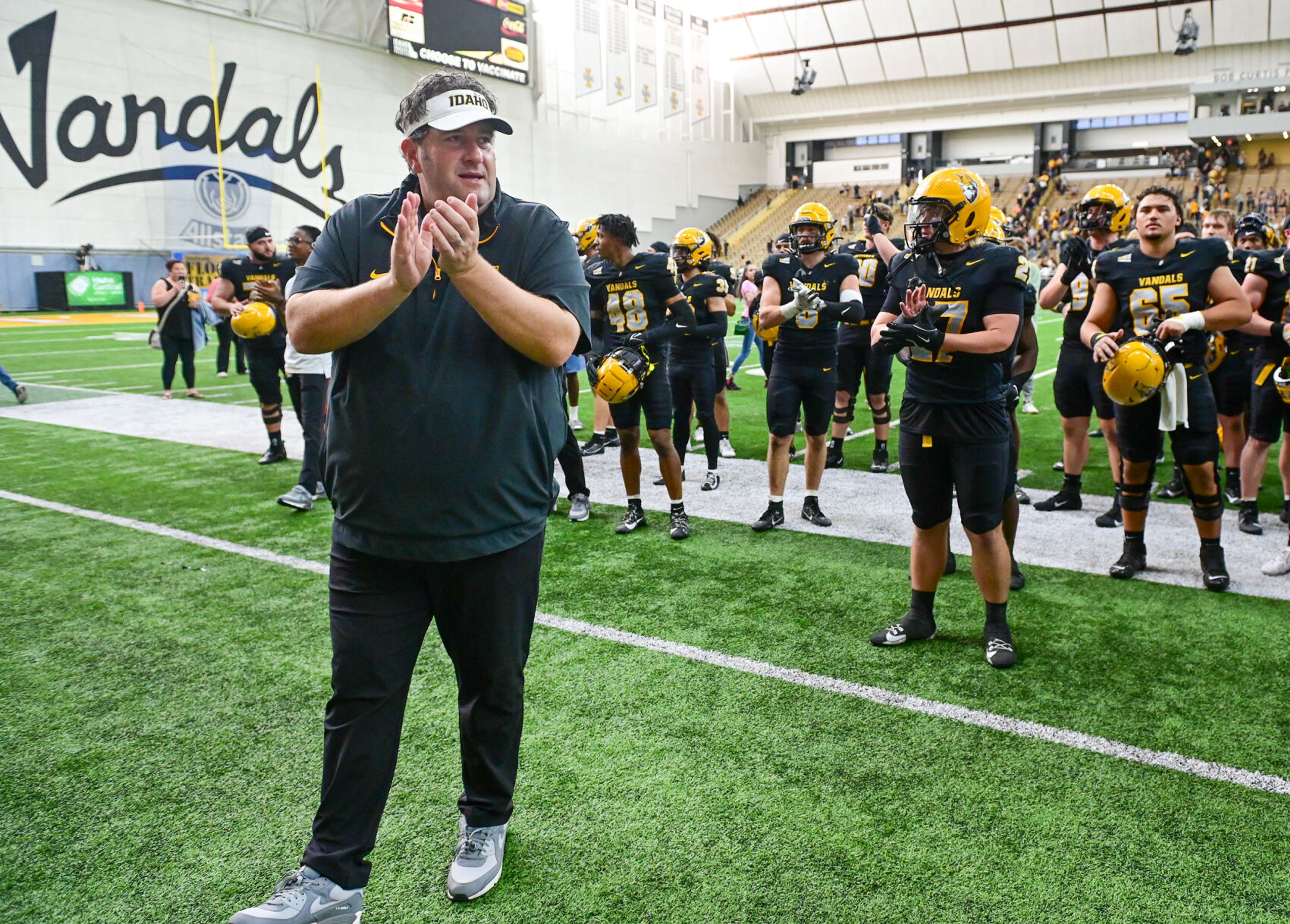 Idaho head coach Jason Eck claps alongside players after a win over UAlbany Saturday at the P1FCU Kibbie Dome in Moscow.