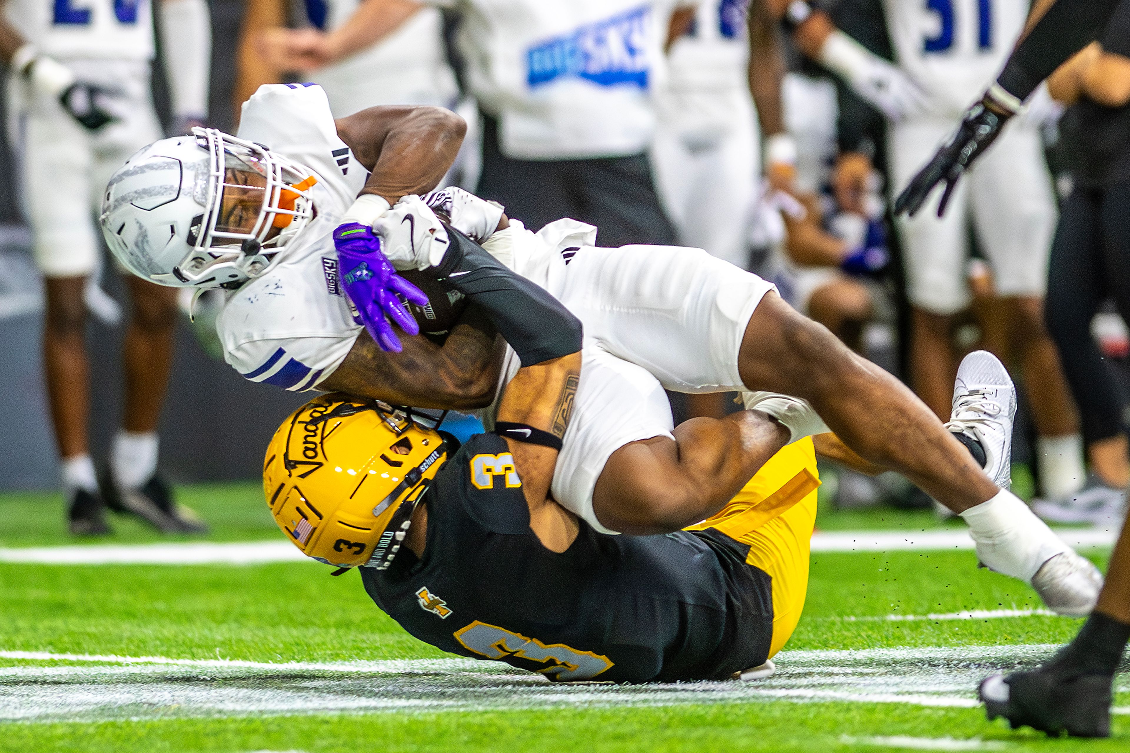 Idaho defensive back K.J. Trujillo tackles Weber State running back Adrian Cormier during a quarter of a Big Sky conference game Saturday at the P1FCU Kibbie Dome in Moscow.