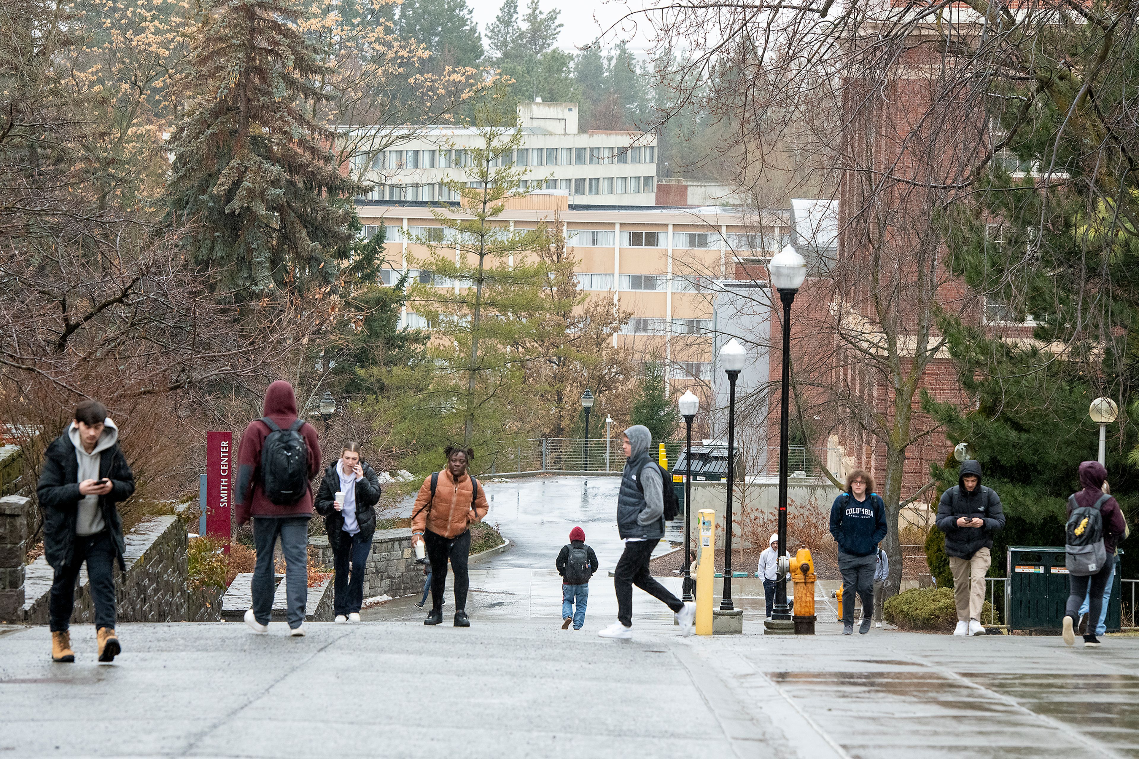 Washington State University students walk through rainfall Monday on the first day of spring semester in Pullman.