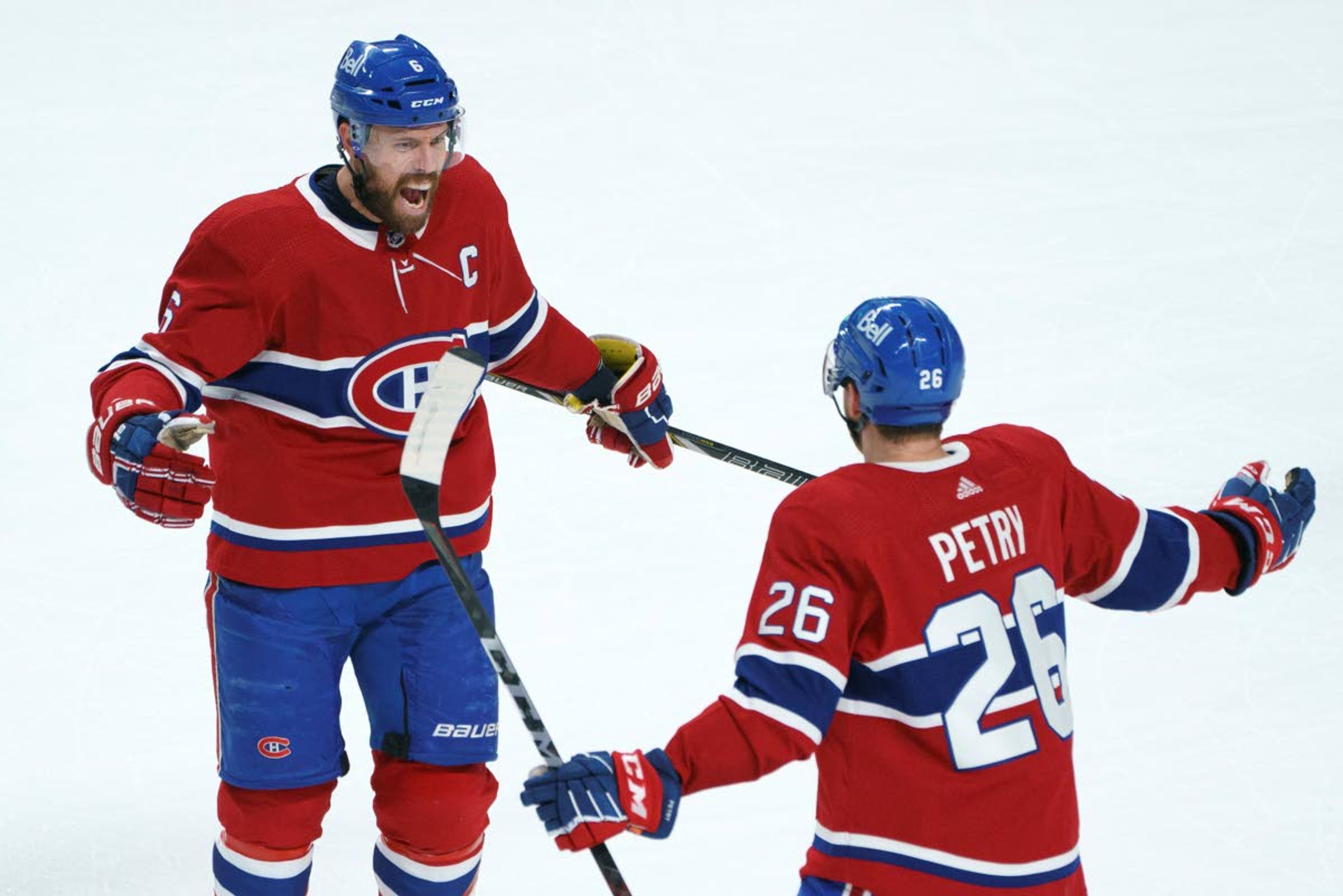 Montreal Canadiens' Shea Weber (6) celebrates his goal with teammate Jeff Petry during the first period in Game 6 of an NHL hockey Stanley Cup semifinal playoff series against the Vegas Golden Knights Thursday, June 24, 2021 in Montreal. (Paul Chiasson/The Canadian Press via AP)