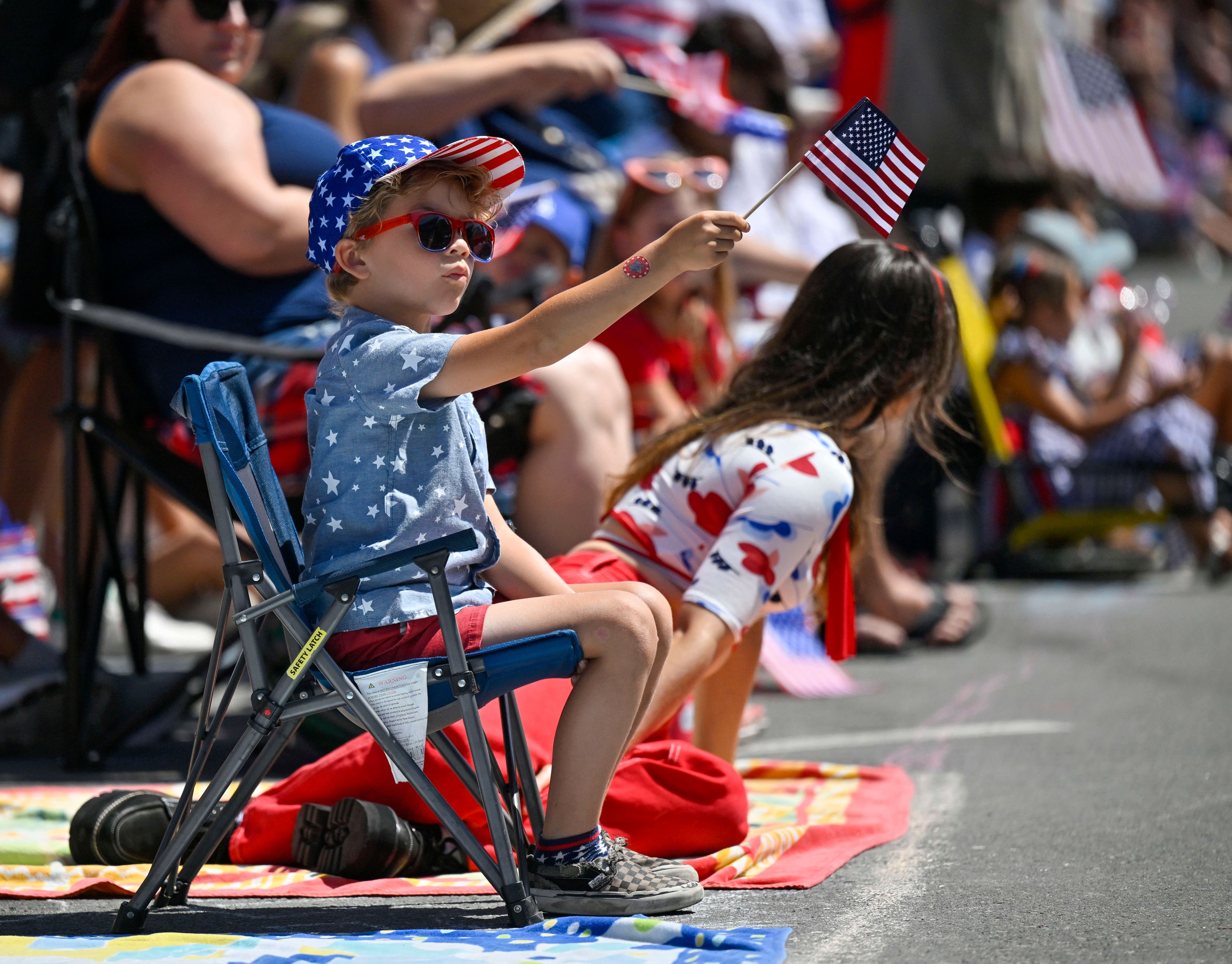 Maverick Flores, 6, watches the 118th Huntington Beach 4th of July Parade in Huntington Beach, Calif.,, on Monday, July 4, 2022. (Jeff Gritchen/The Orange County Register via AP)