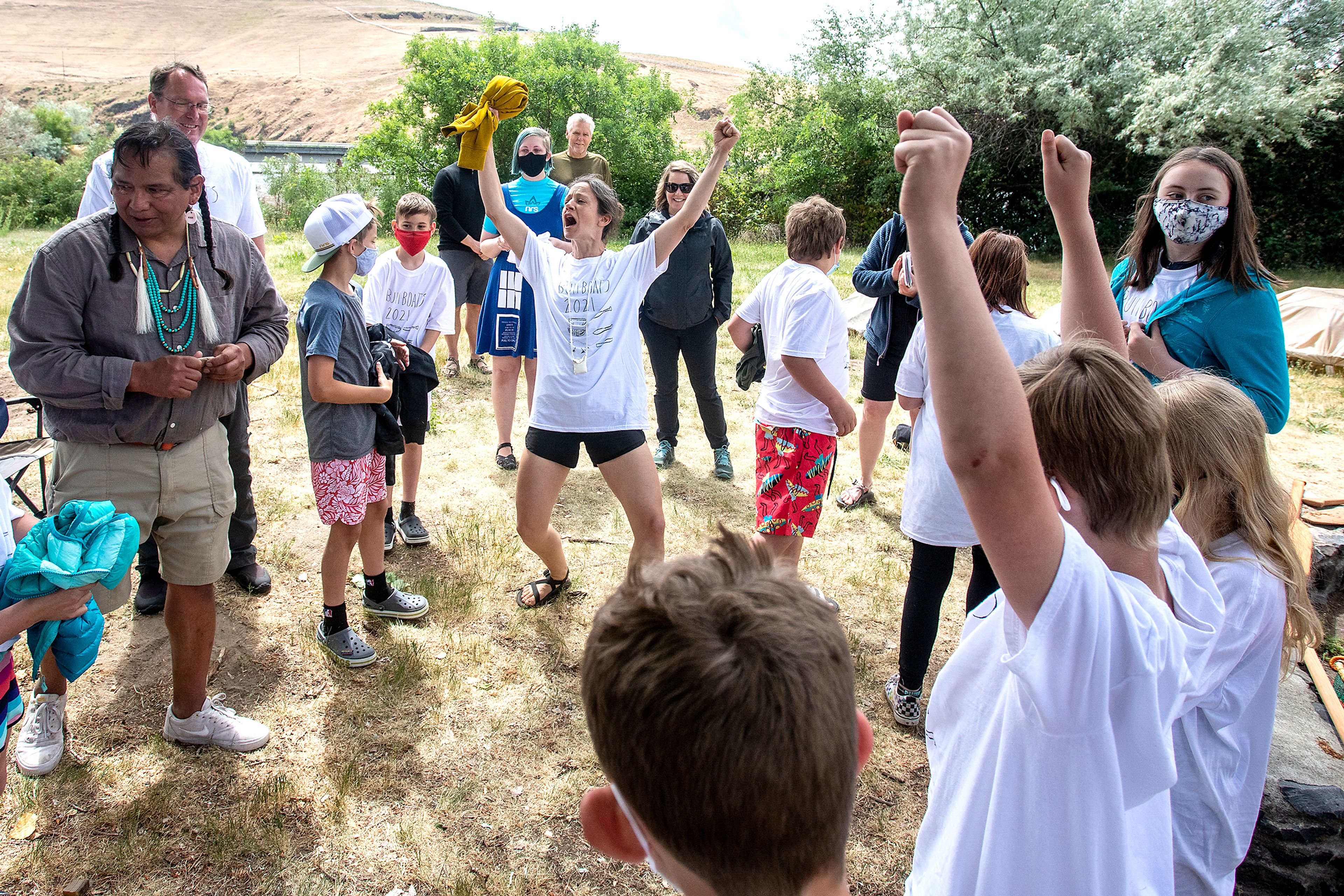 Renee Hill raises her arms in the air as she yells “let’s see if these things float,” as she and her class with Palouse Prairie Charter School get ready to test out three bull boats they constructed.