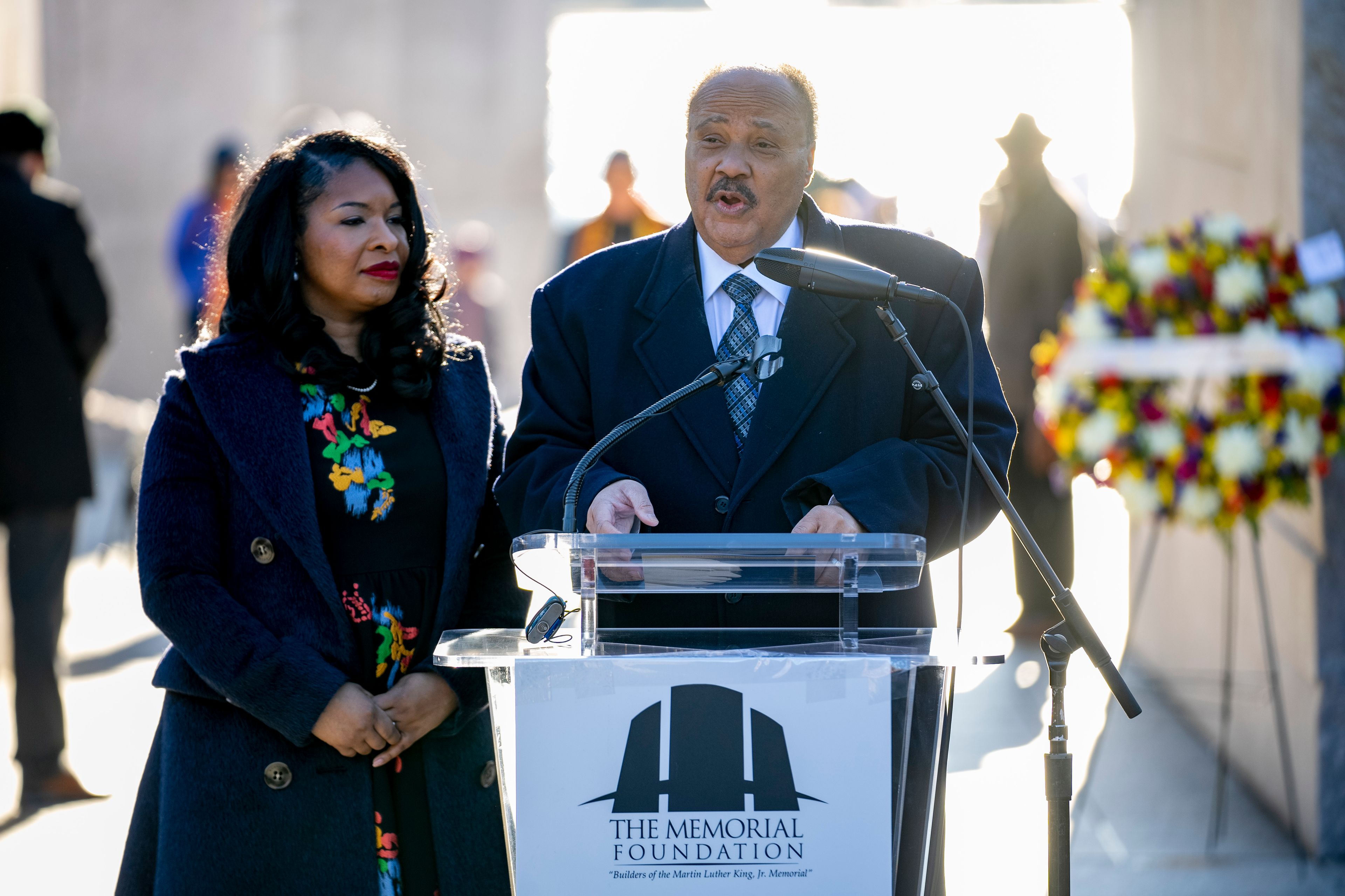 Martin Luther King III, center, the son of Martin Luther King Jr., accompanied by his wife Arndrea Waters King, both with the Drum Major Institute, speaks during a wreath-laying ceremony at the Martin Luther King Jr. Memorial on Martin Luther King Jr. Day in Washington, Monday, Jan. 16, 2023. (AP Photo/Andrew Harnik)