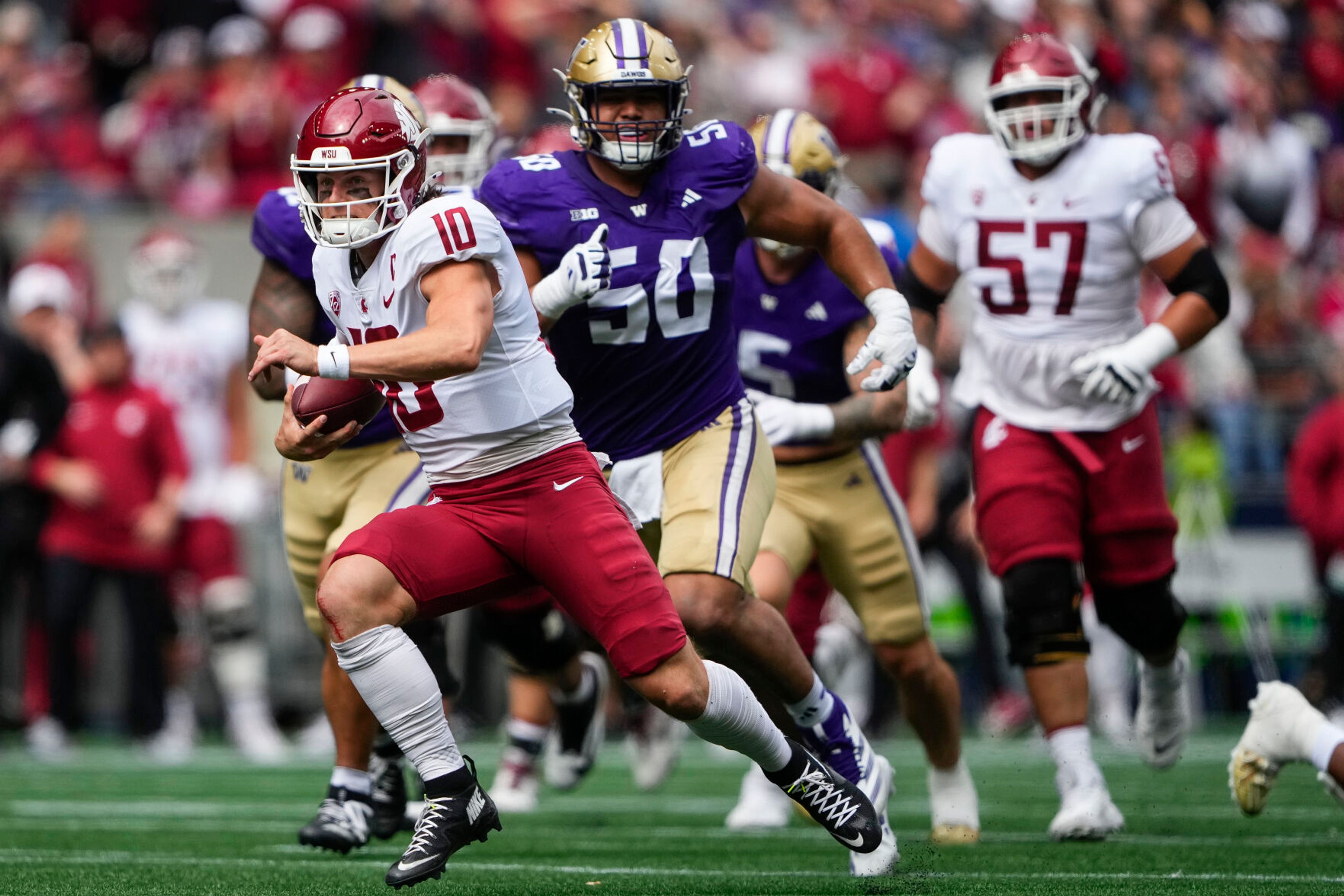 Washington State quarterback John Mateer (10) runs for a touchdown against Washington defensive tackle Sebastian Valdez (50) during the first half of an NCAA college football game Saturday, Sept. 14, 2024, in Seattle. (AP Photo/Lindsey Wasson)