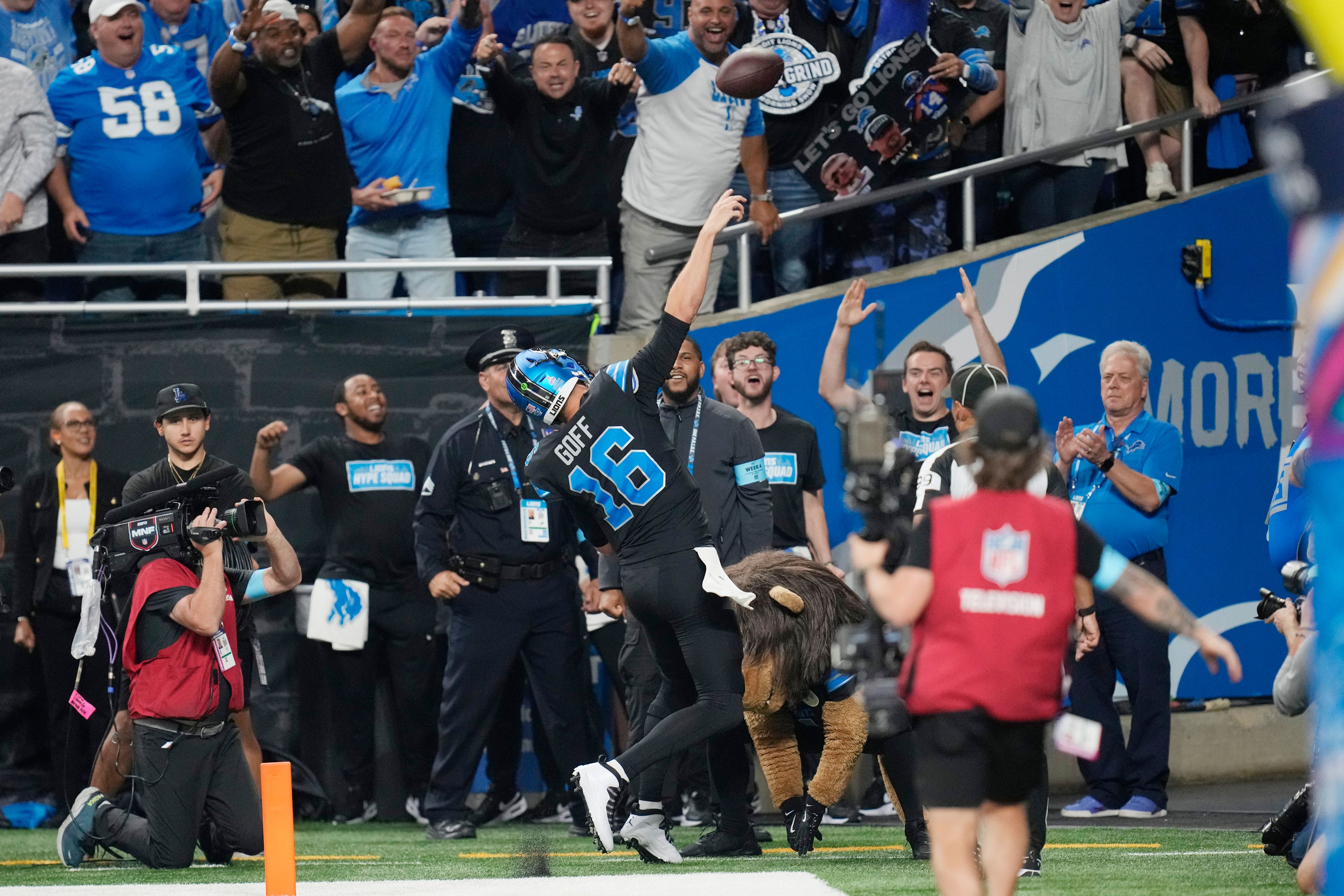 Detroit Lions quarterback Jared Goff tosses the football into the stands after his rushing touchdown during the second half of an NFL football game against the Seattle Seahawks, Monday, Sept. 30, 2024, in Detroit. (AP Photo/Paul Sancya)