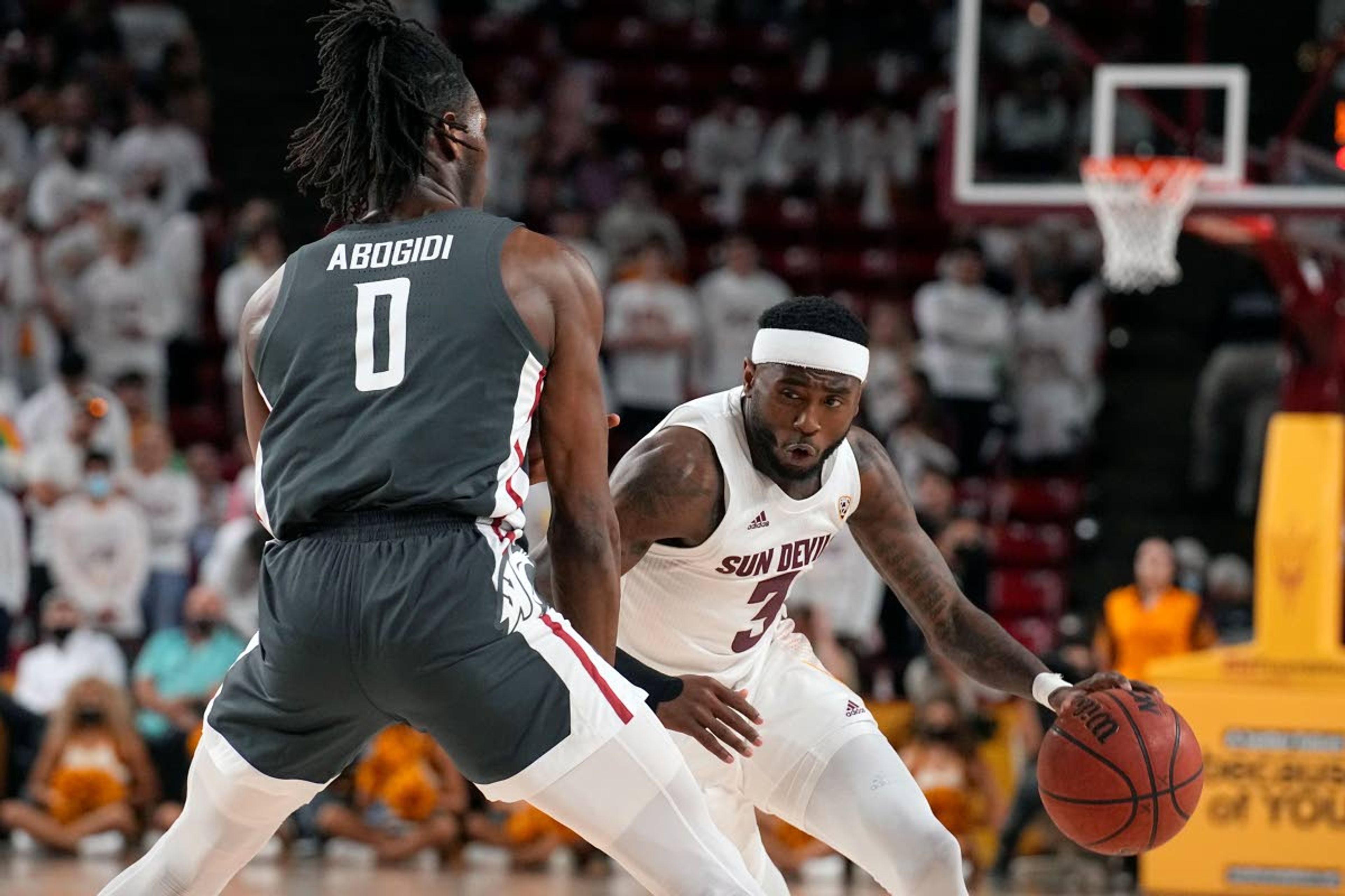 Arizona State guard Marreon Jackson drives on Washington State forward Efe Abogidi (0) during the second half of an NCAA college basketball game, Wednesday, Dec. 1, 2021, in Tempe, Ariz. Washington State won 51-29. (AP Photo/Rick Scuteri)