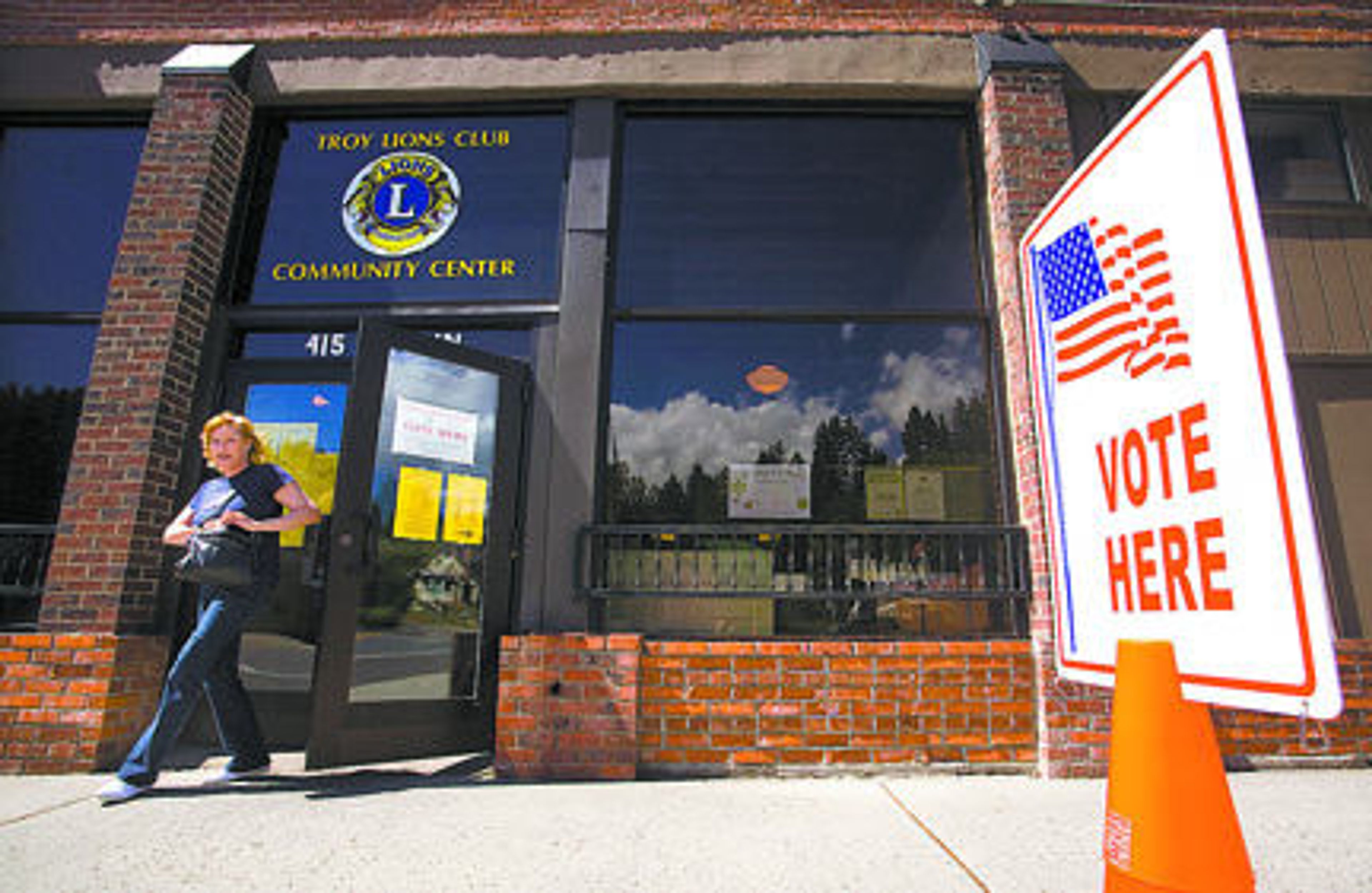 A woman exits the Troy Lions Club Community Center after voting in the primary election and the school levy election on tuesday.