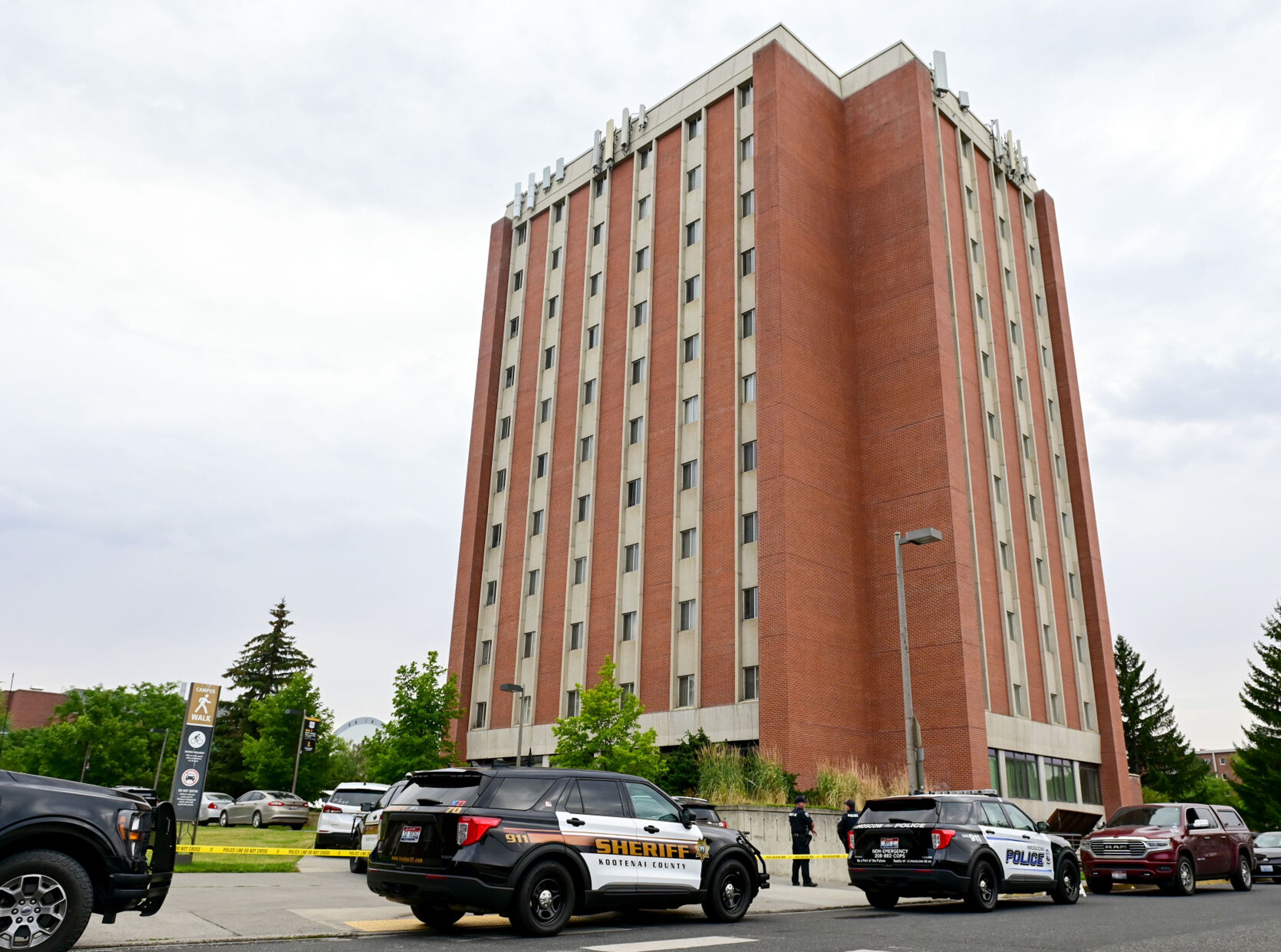 Police cars park behind Theophilus Tower on the University of Idaho campus after an inmate walked away from a cleaning crew on Tuesday in Moscow.