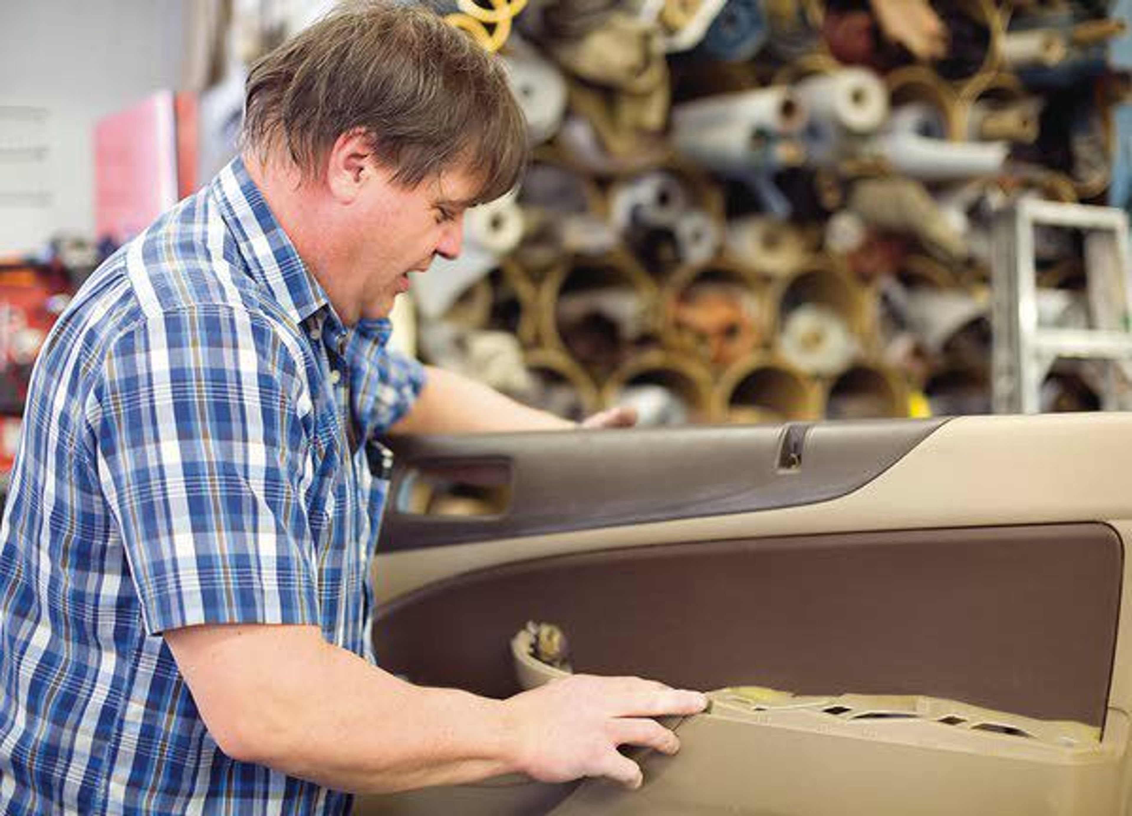 David Gludt works on a car door he was upholstering on Jan. 27 at Dido Upholstery of Troy. The business was started 58 years ago by Gludt’s father.