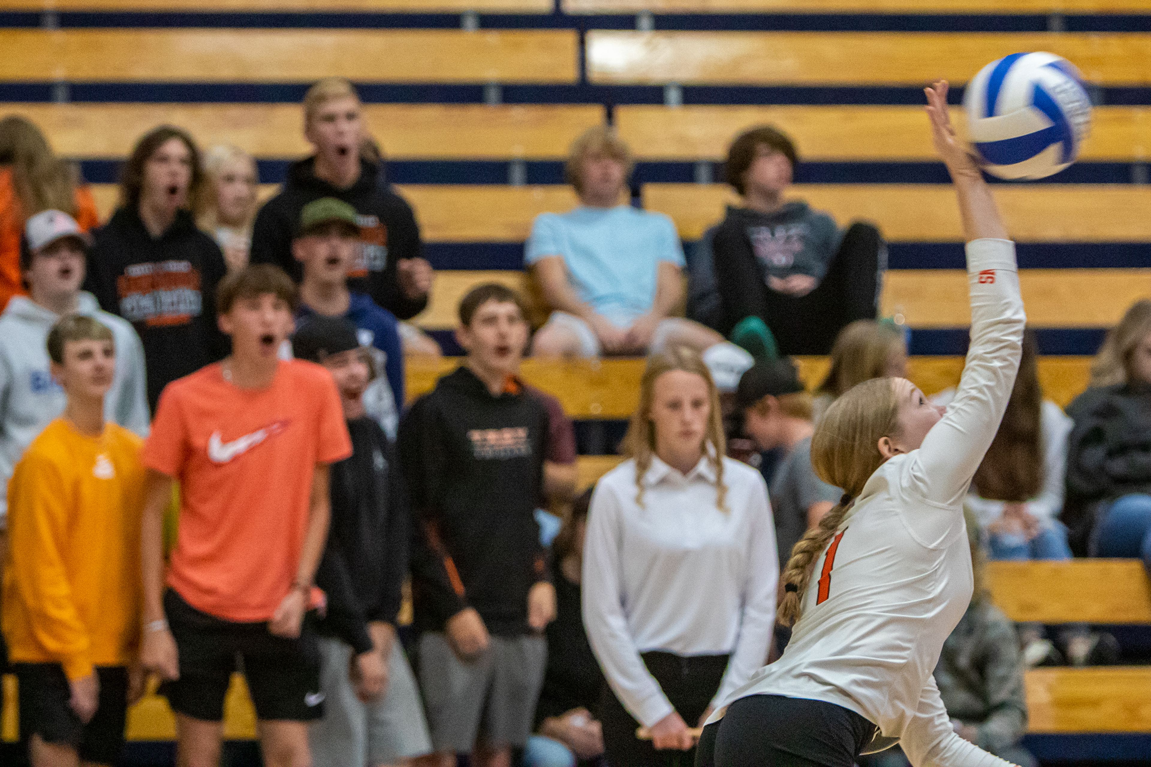 Troy High libero Nicole Hunter serves to Genesee High as her student section cheers her on during the Idaho Class 1A Division I district volleyball tournament at the P1FCU Activity Center in Lewiston on Wednesday.