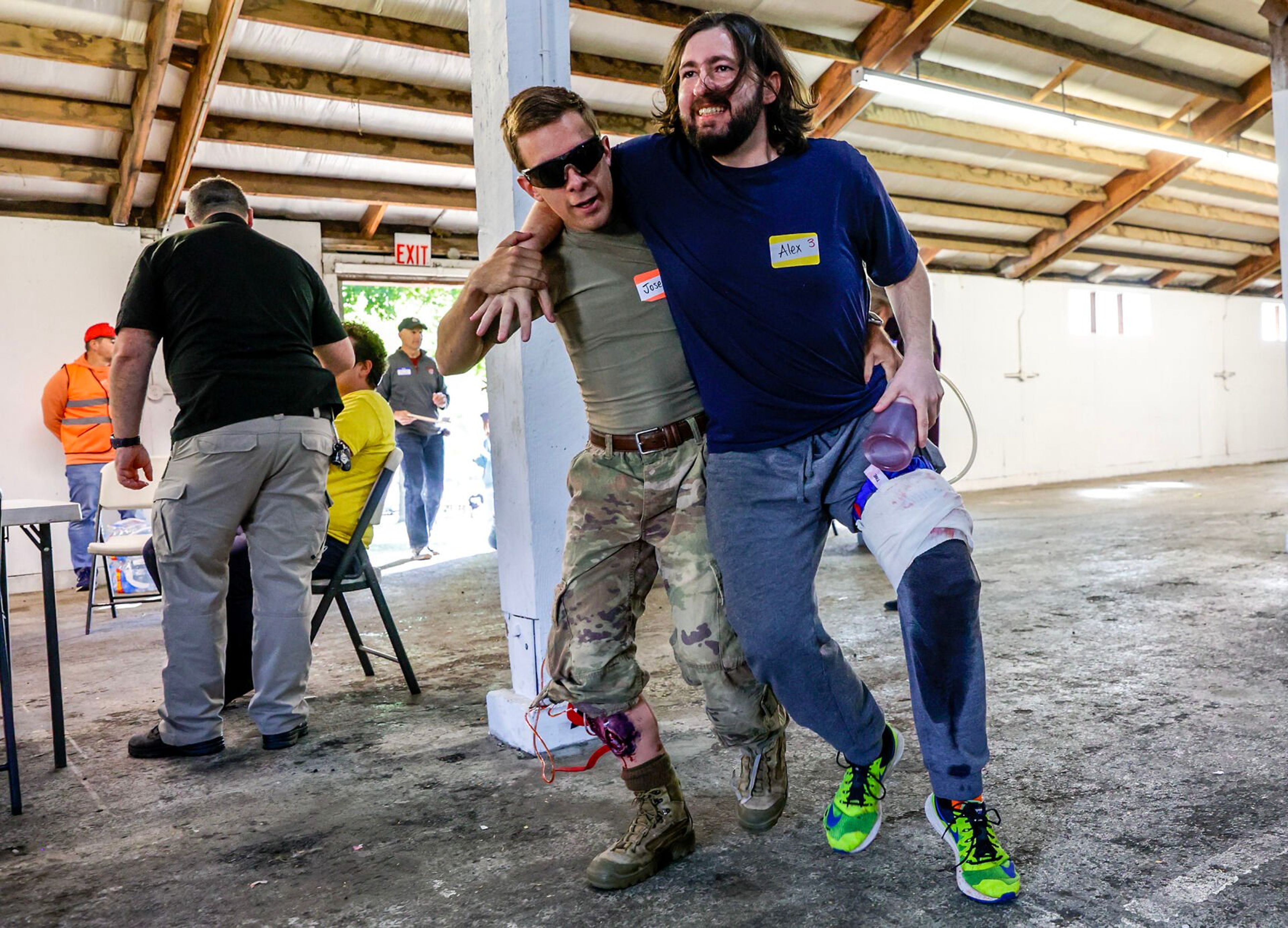 Alex Gelinas is helped to a chair as his leg bleeds during a disaster simulation of a windstorm Saturday at the Latah County Fairgrounds.