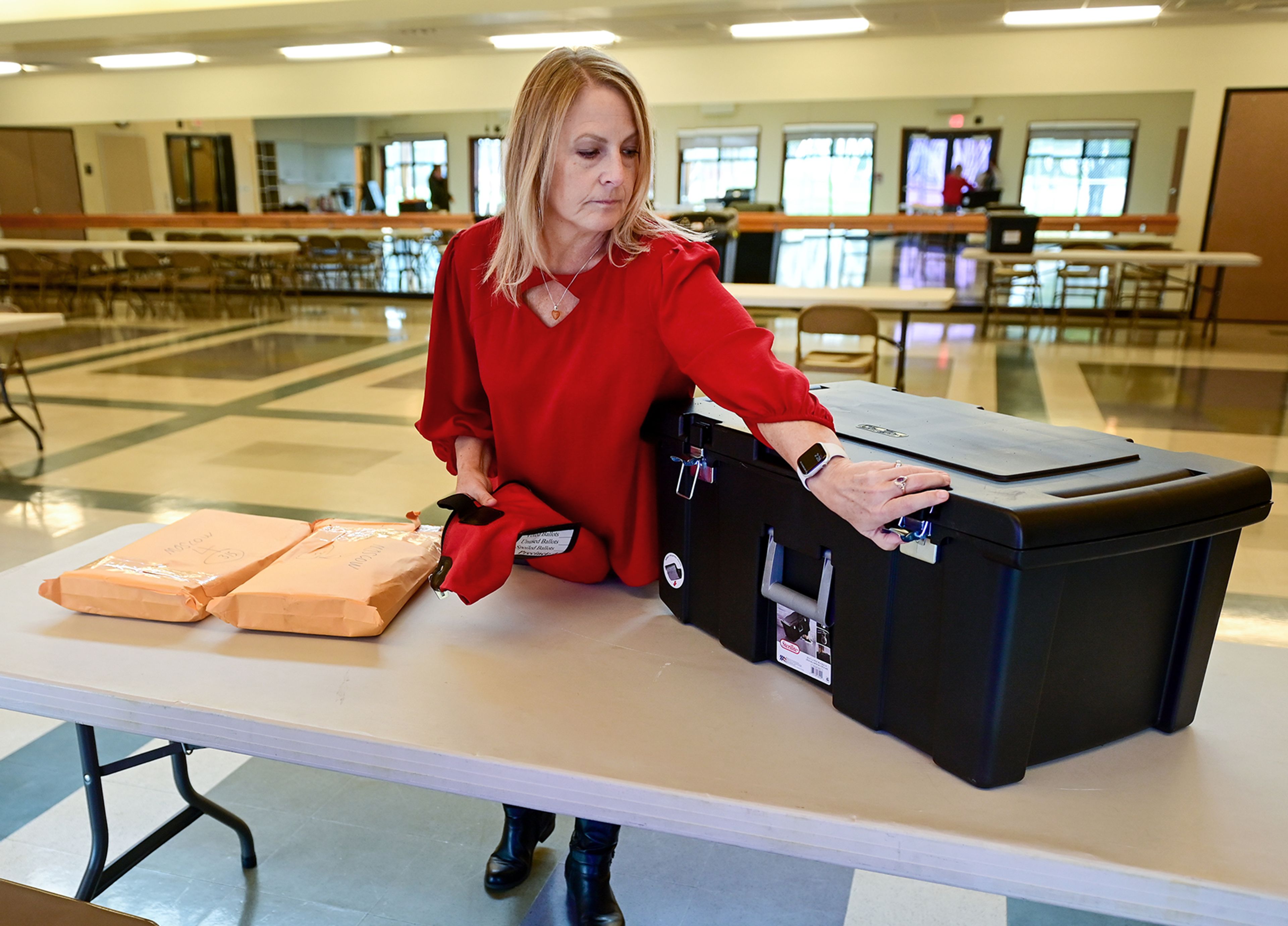 Laurie Hopkins, Moscow City Clerk, organizes polling supplies Monday at the Hamilton Indoor Recreation Center, a polling location for Latah County, in Moscow.