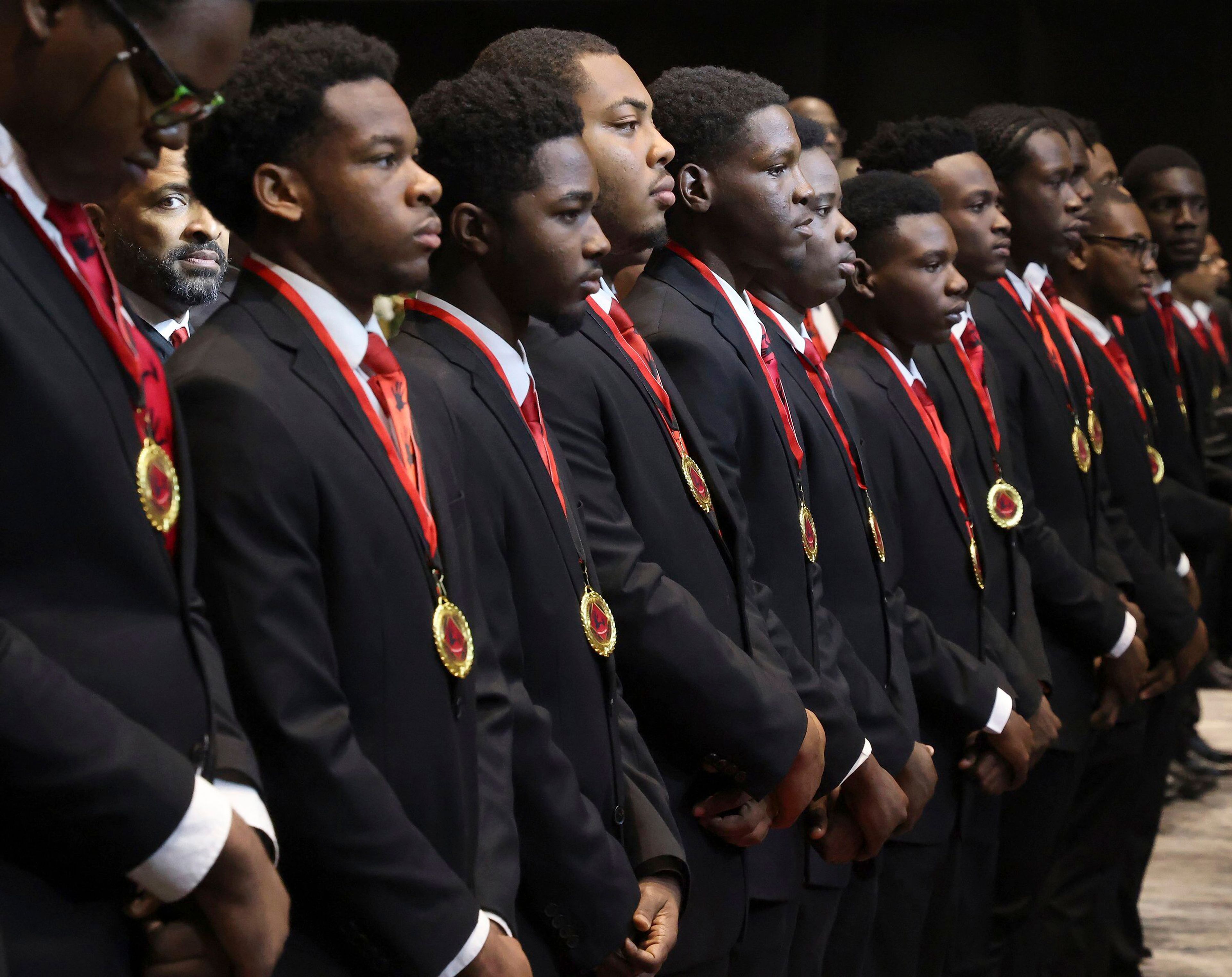 The 49 members of the Wilson Scholars Class of 2023 stand facing the audience wearing their medallions after the processional and medallion ceremony during the Annual Dr. Martin Luther King, Jr. Scholarship Breakfast Monday, Jan. 16, 2023, at the Miami Beach Convention Center. The 5000 Role Models of Excellence Project celebrated its 30th Anniversary with a keynote address by Douglas Emhoff, the second gentleman of the U.S., who is married to the first female vice president, as the organization honored 2023 Wilson Scholars, Philanthropic Mentors, and inducted Models of Excellence. (Carl Juste/Miami Herald via AP)