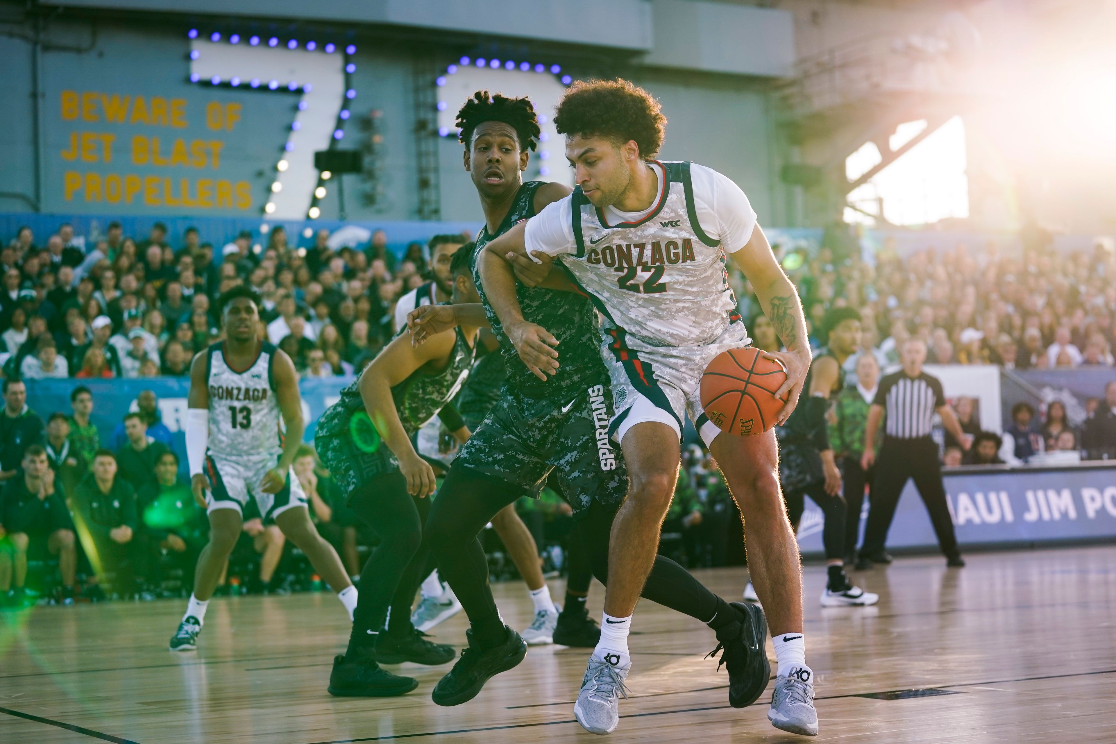 Gonzaga forward Anton Watson (22) controls the ball against Michigan State guard A.J. Hoggard (11) during the first half of the Carrier Classic NCAA college basketball game aboard the USS Abraham Lincoln in Coronado, Calif. Friday, Nov. 11, 2022. (AP Photo/Ashley Landis)