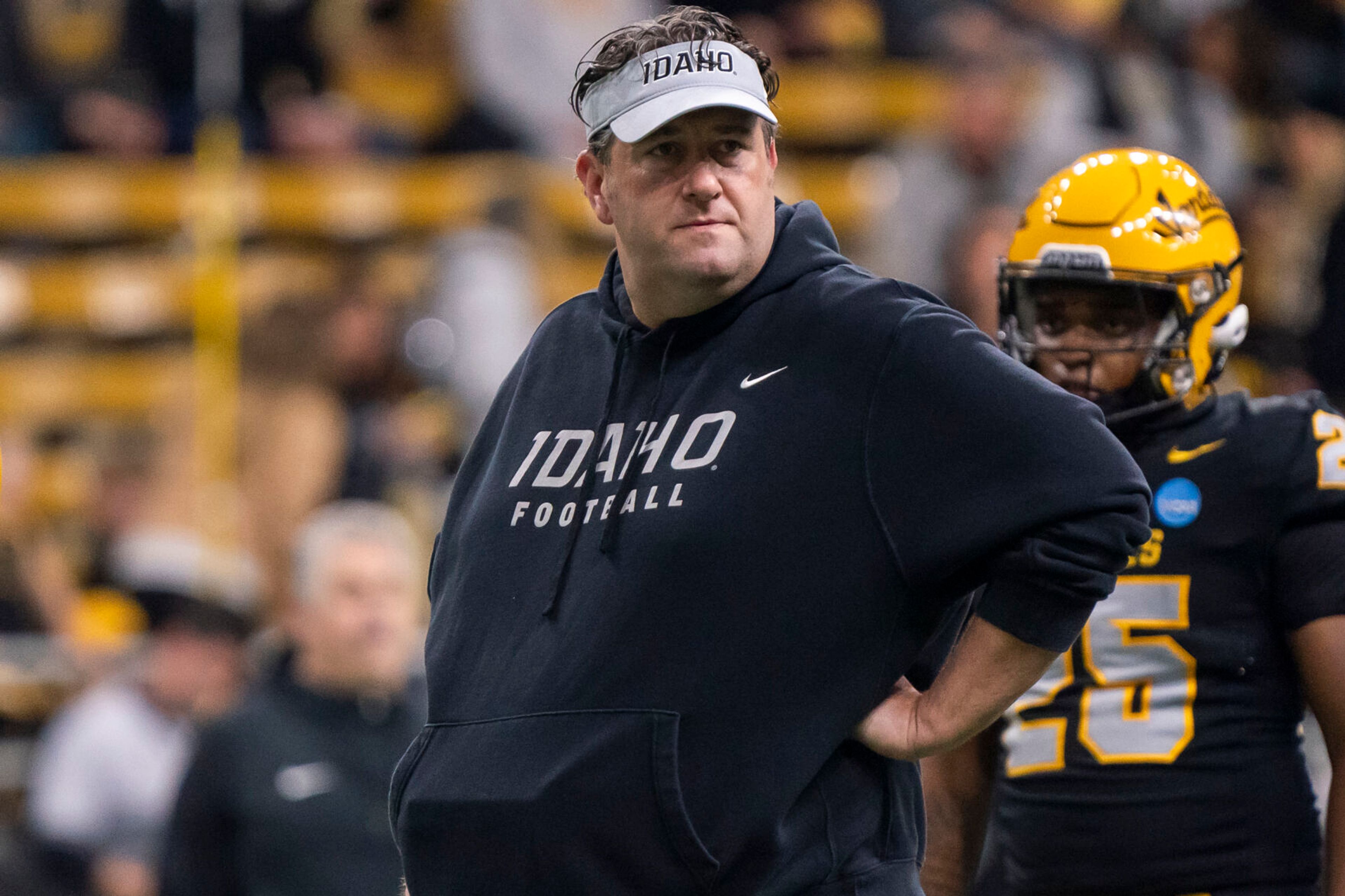 Idaho Vandals head coach Jason Eck watches his team warm-up before their game against Albany in the third round of the 2023 Division I FCS Football Championship on Saturday inside the Kibbie Dome in Moscow.