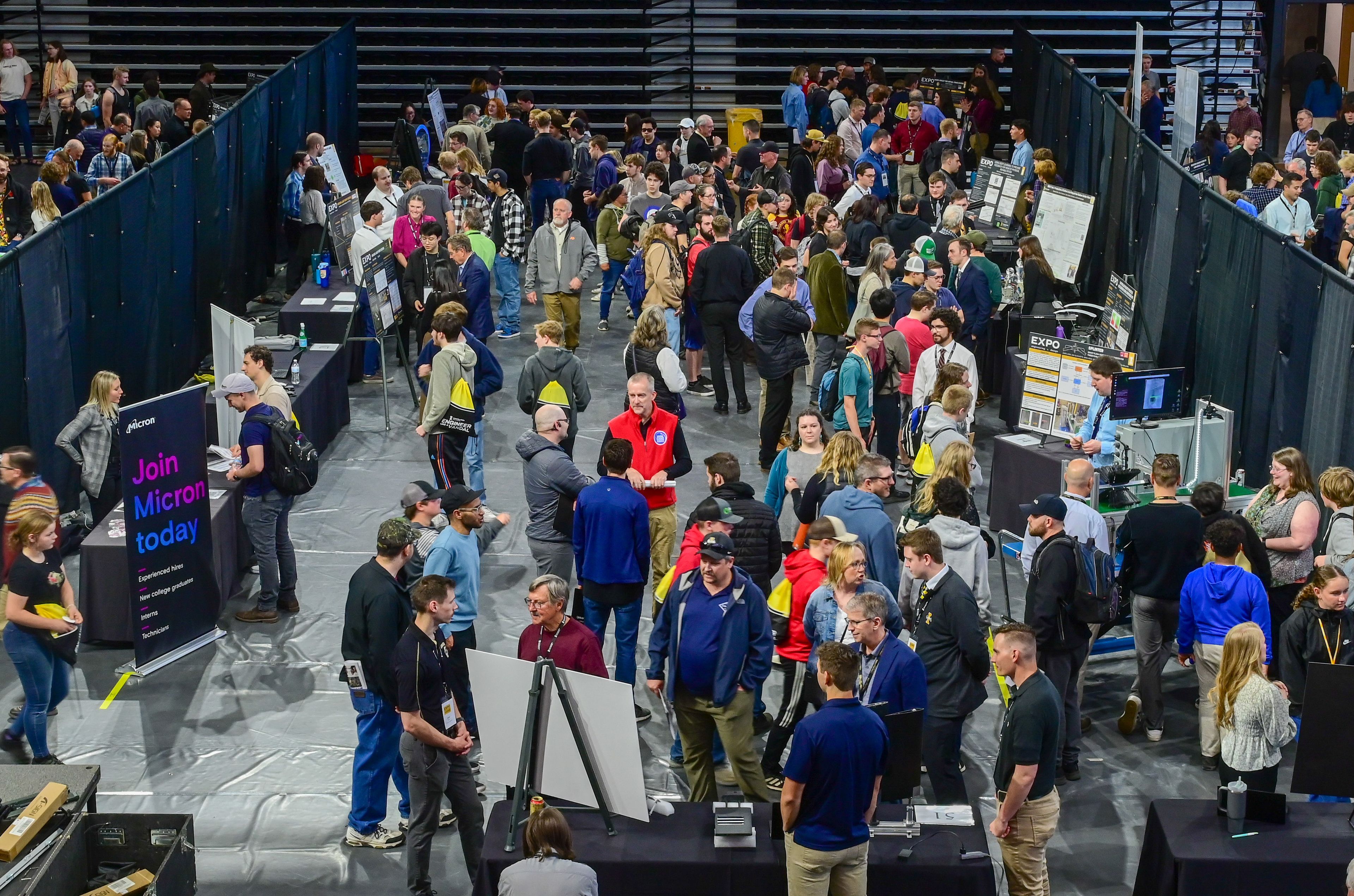 Visitors walk between student capstone presentations at the Engineering Design EXPO in Moscow on Friday.