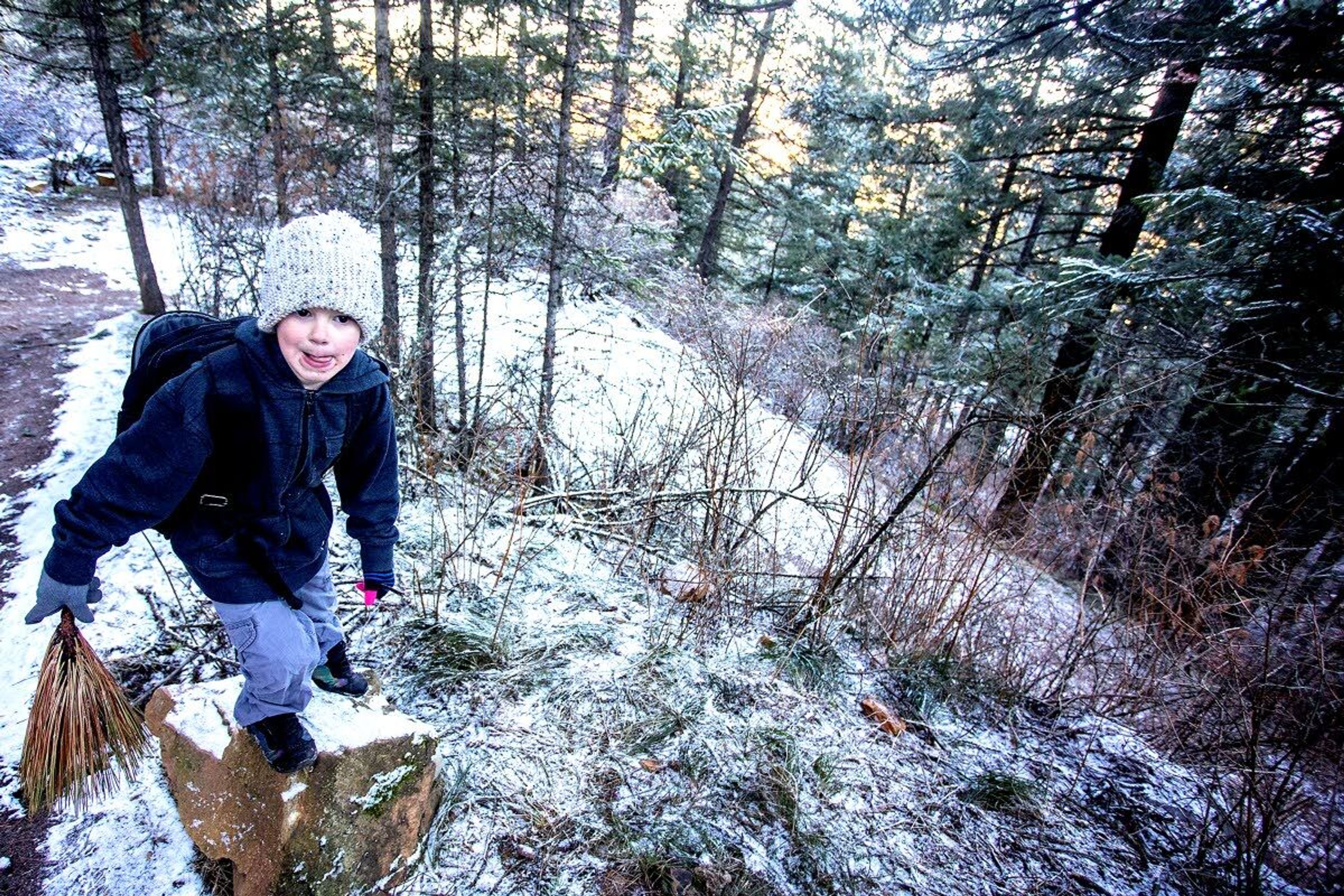 Bobby Anderson, 7, prepares to jump down from a rock while hiking up the Pine Ridge Trail to the Kamiak Butte summit on Saturday.