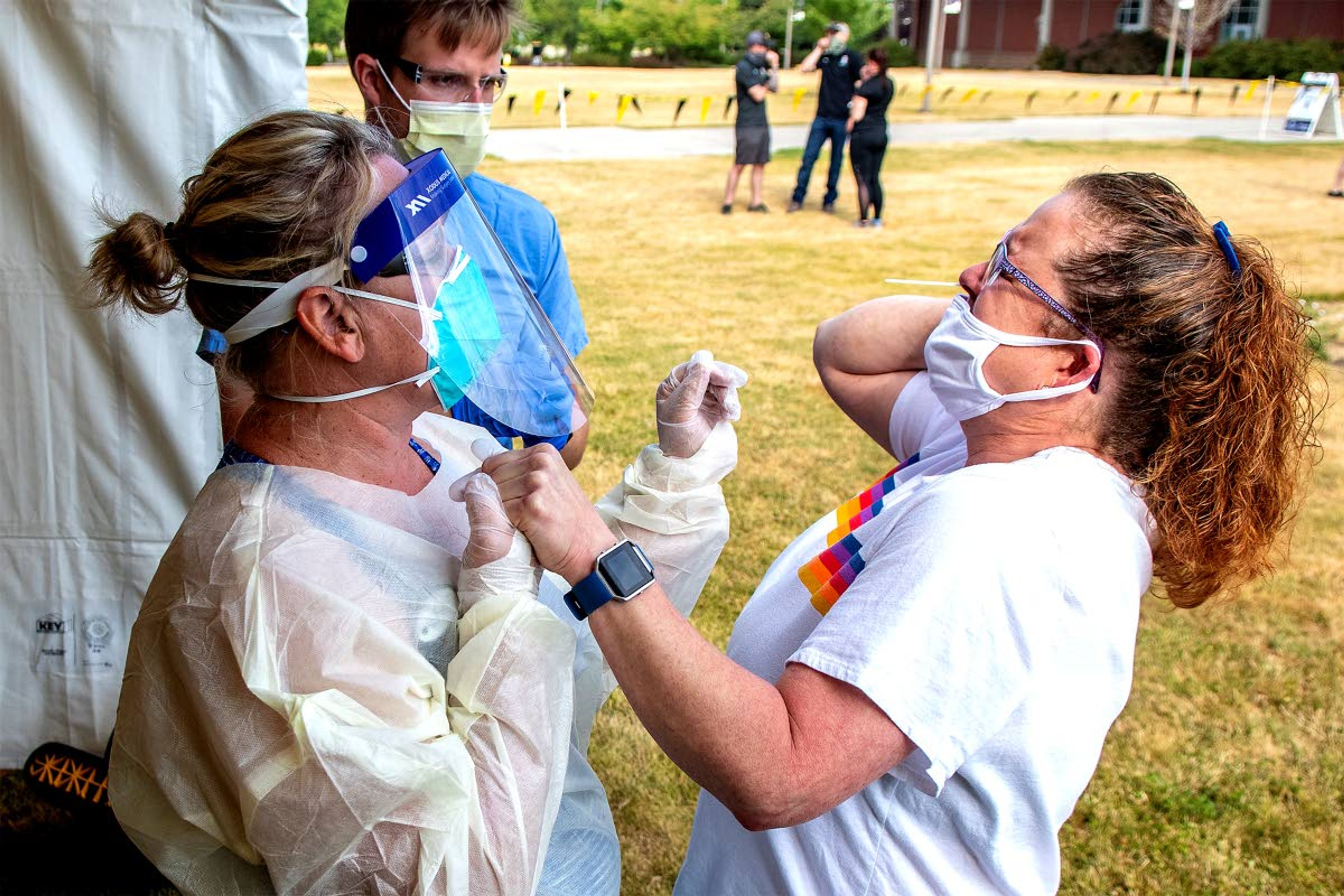 Kelli Sirotzki winces and holds Alecia Hart’s hand as she endures 17 seconds of a cotton swab in her nose to test for COVID-19 on Wednesday in Moscow.August Frank Lewiston Tribune