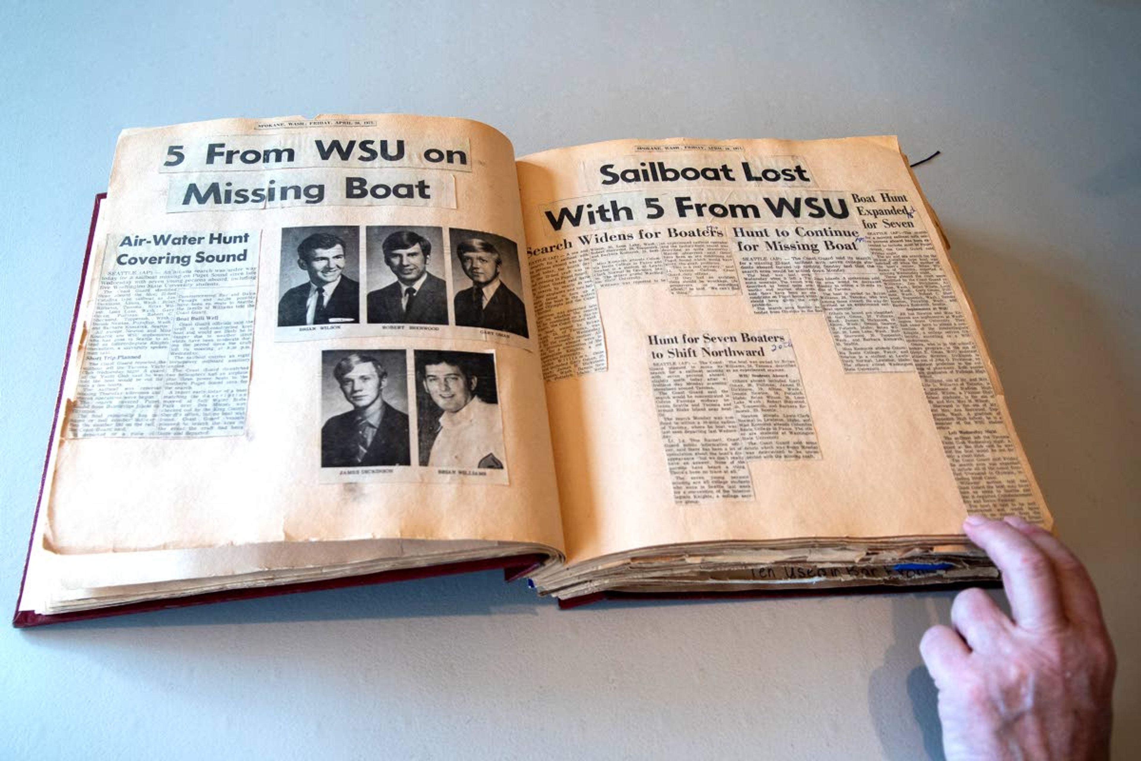 Zach Wilkinson/Daily NewsJudge Gary Libey flips through pages of his scrapbook as he shares memories about a tragic boating accident on Puget Sound that took the lives of seven college students, including five from Washington State University, 50 years ago.