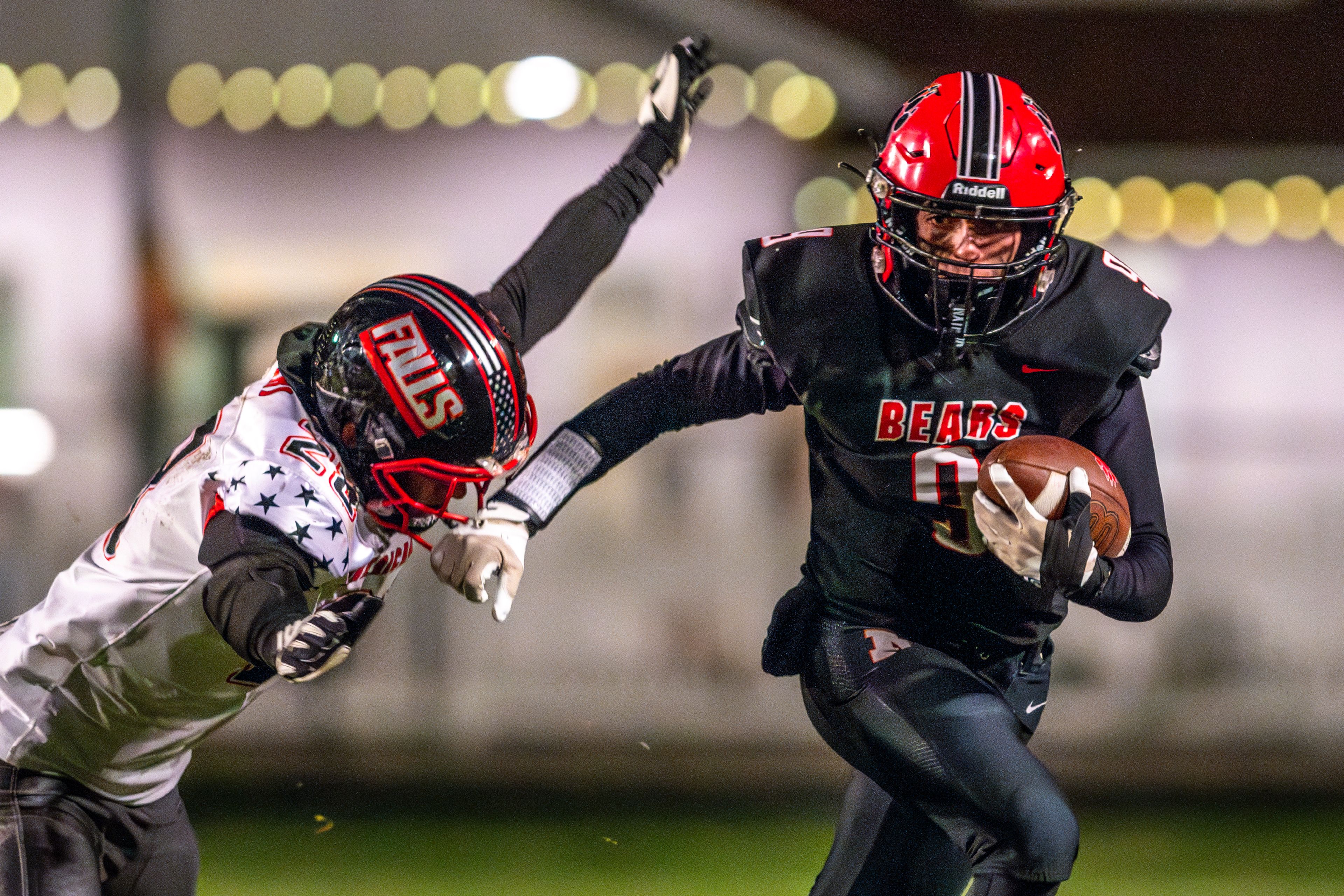 Moscow running back Tyson Izzo runs down field as American Falls' Austin Adair looks to stop him during an Idaho 4A playoff game Friday in Moscow.