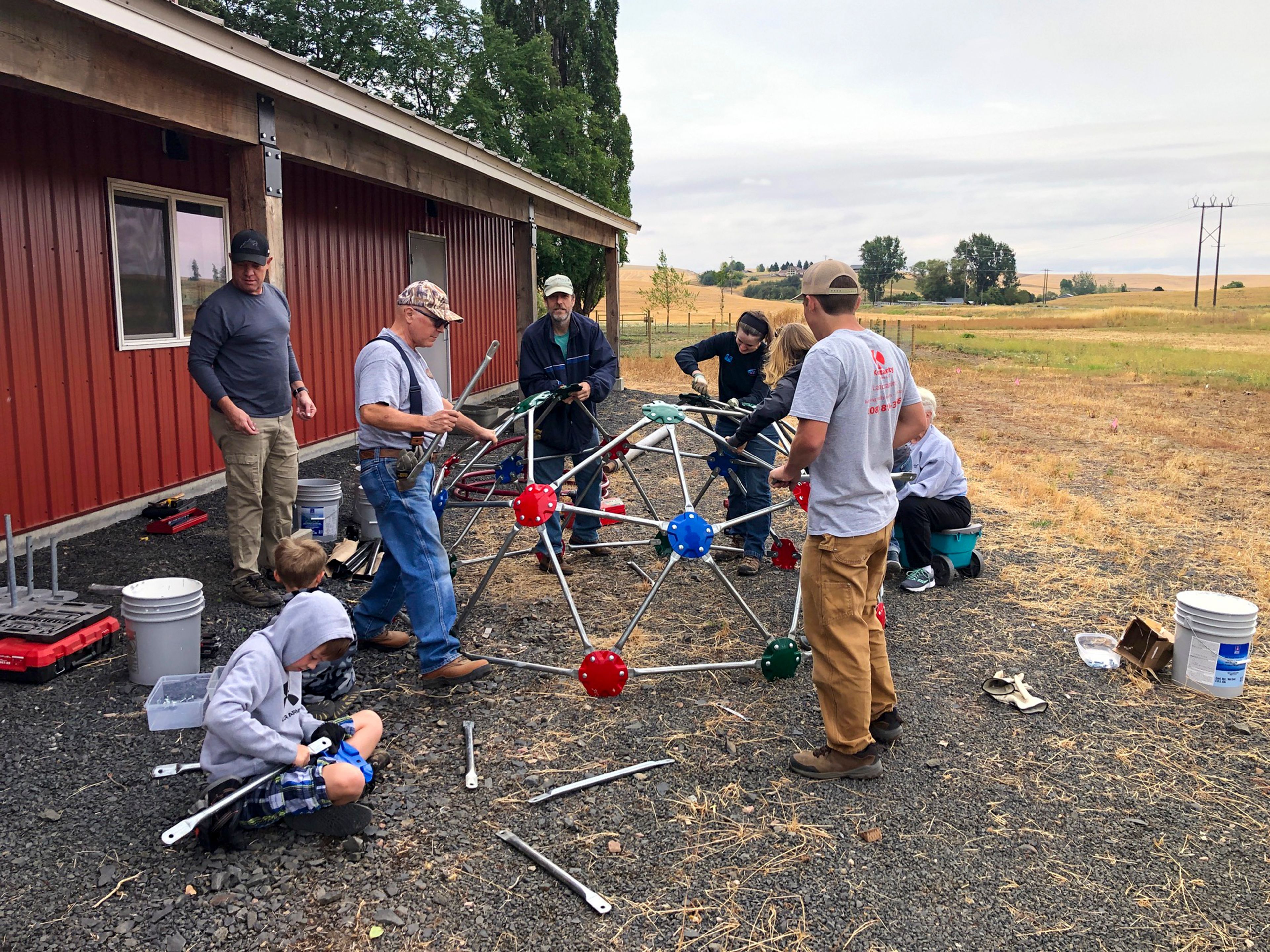 Viola community members work together to construct a playground outside of the Viola Community Center on Sunday, July 9, 2022.