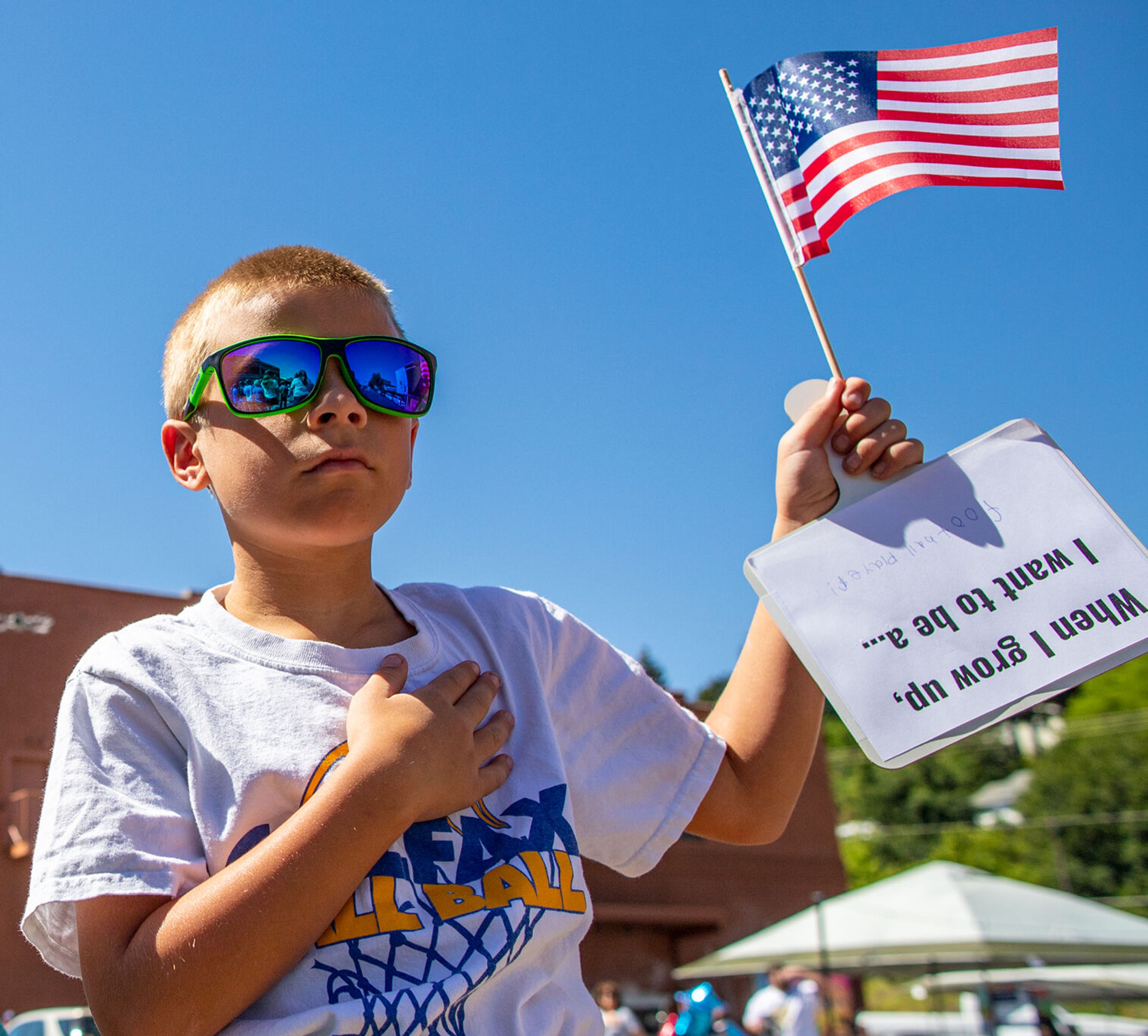 Bryson Batterton, 9, of Coflax, honors his country with a hand over his heart while the National Anthem its played Saturday during the city of Colfax’s 150th birthday celebration.