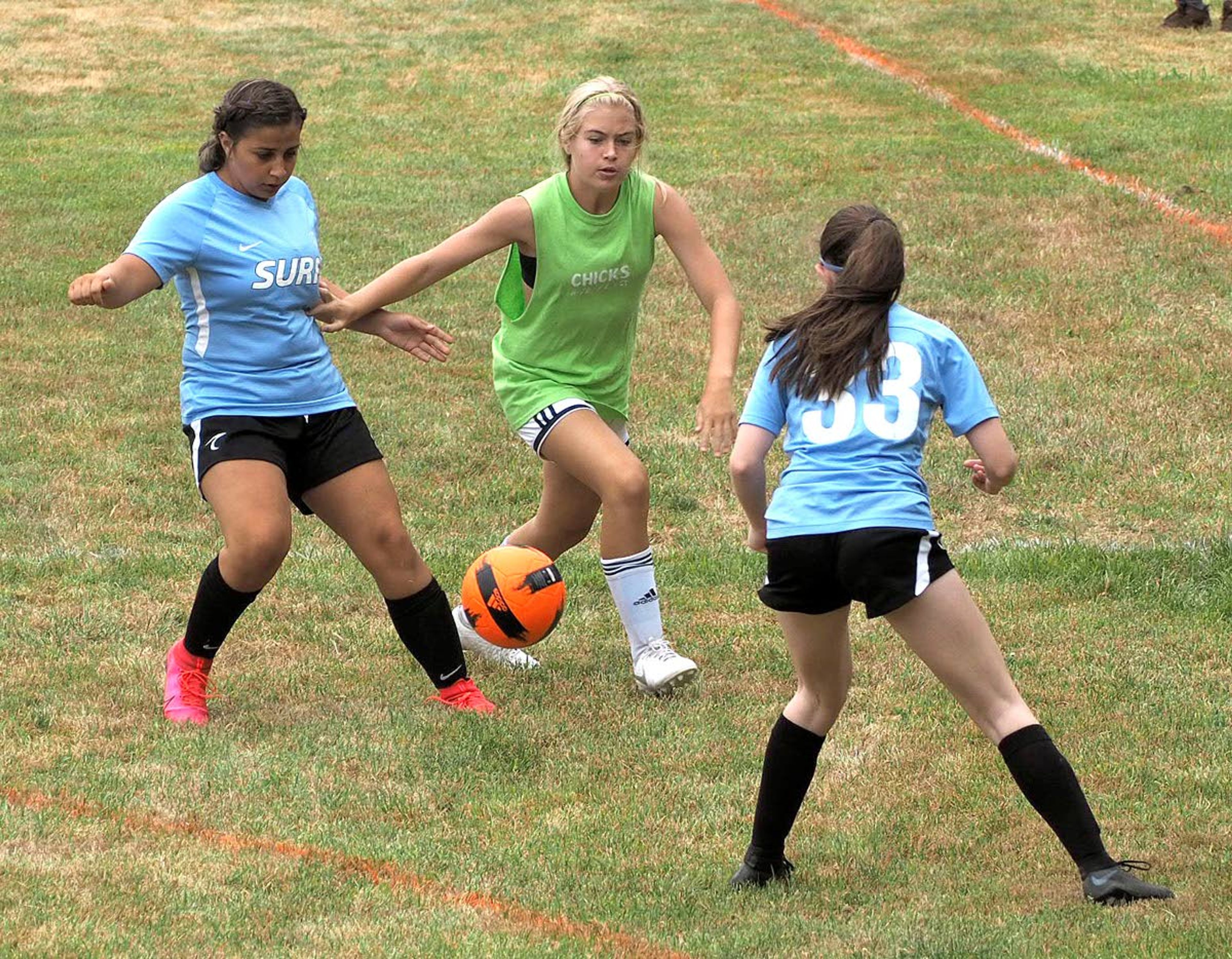 Girls play in a soccer game on Saturday during the Eastern Washington Surf Soccer Club Harvest Cup soccer tournament at Oylear Field in Moscow. The tournament was shut down on Sunday for violating the Moscow Mayor's order to wear masks in public places when social distancing isn't possible.