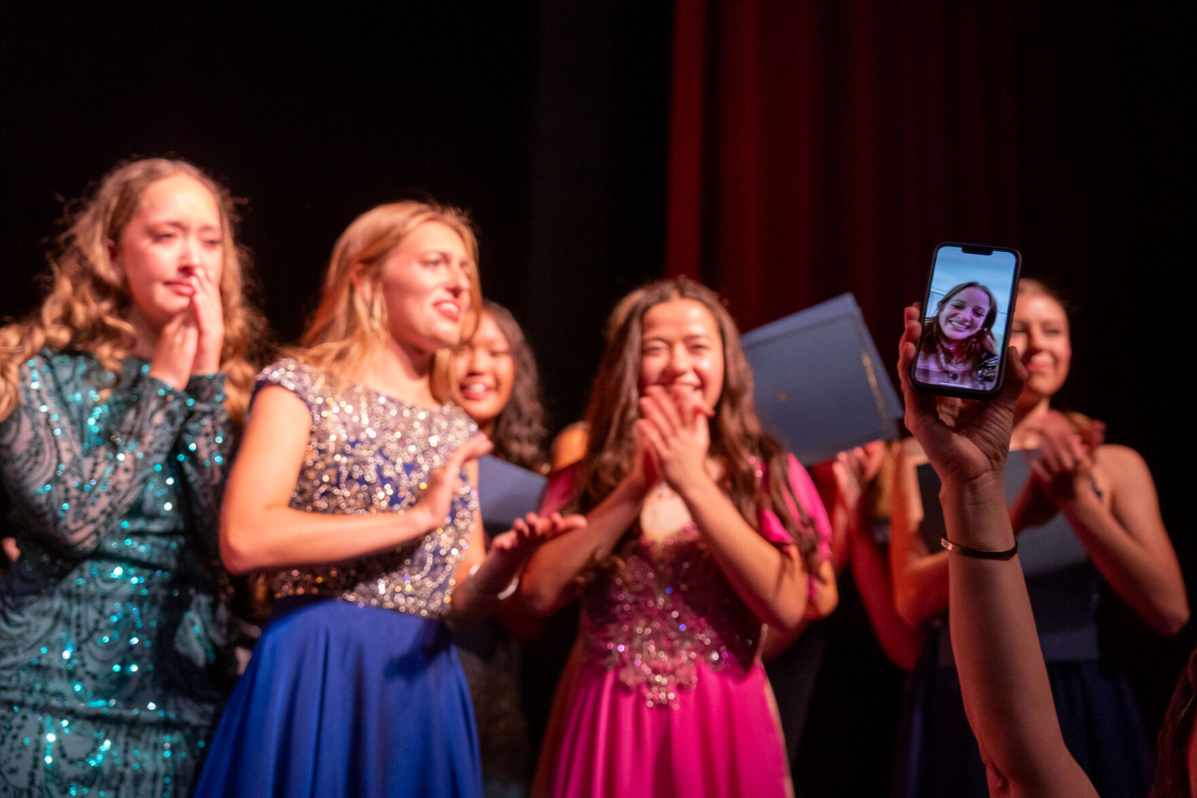 Washington Distinguished Young Woman competitors applaud Sydney Ohlemann, right, as she appears on a call after winning the competiton on Saturday at Daggy Hall in Pullman.