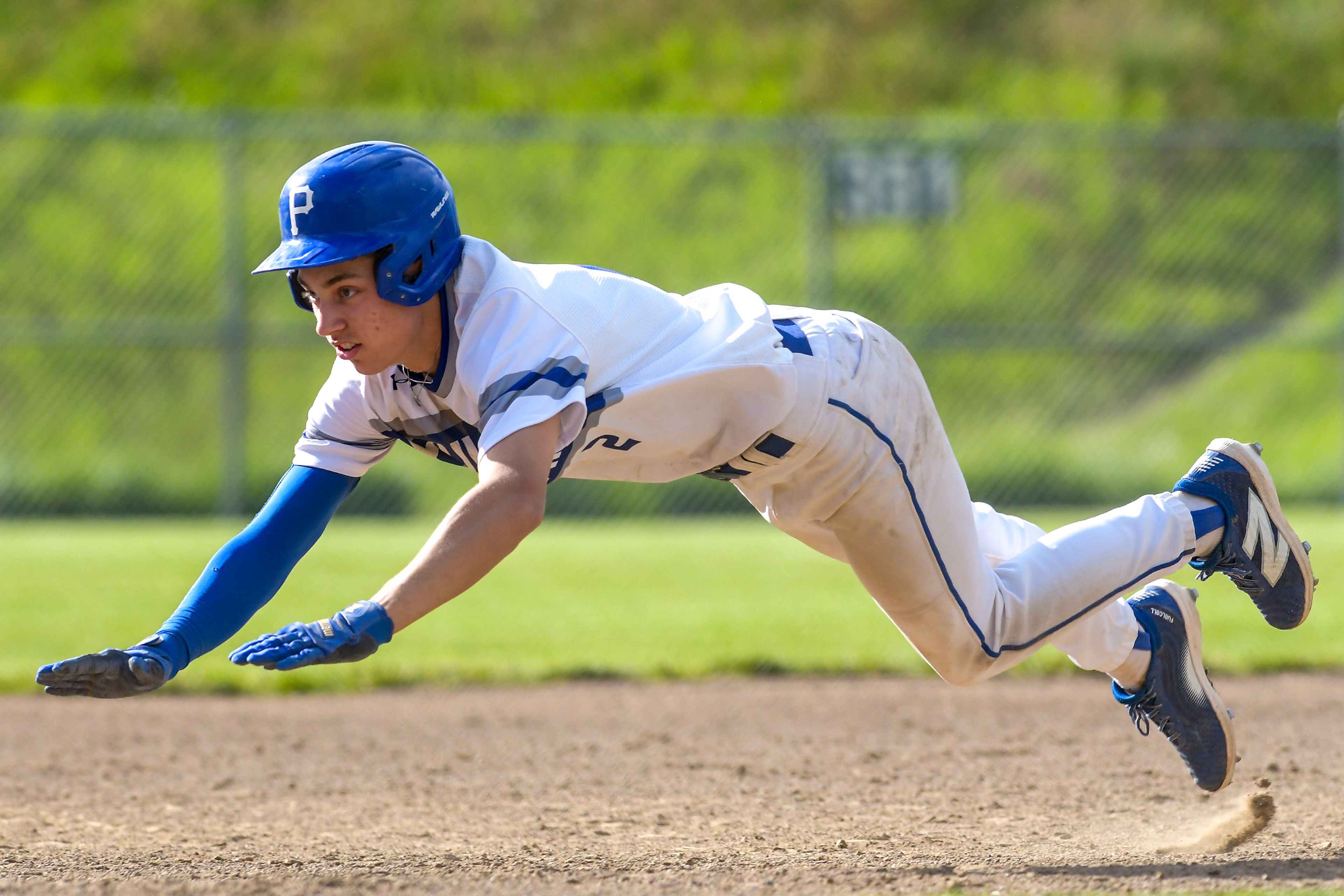 Pullman’s Brayden Randall dives into third base against Clarkston during a semifinal game of the district tournament Thursday in Pullman.