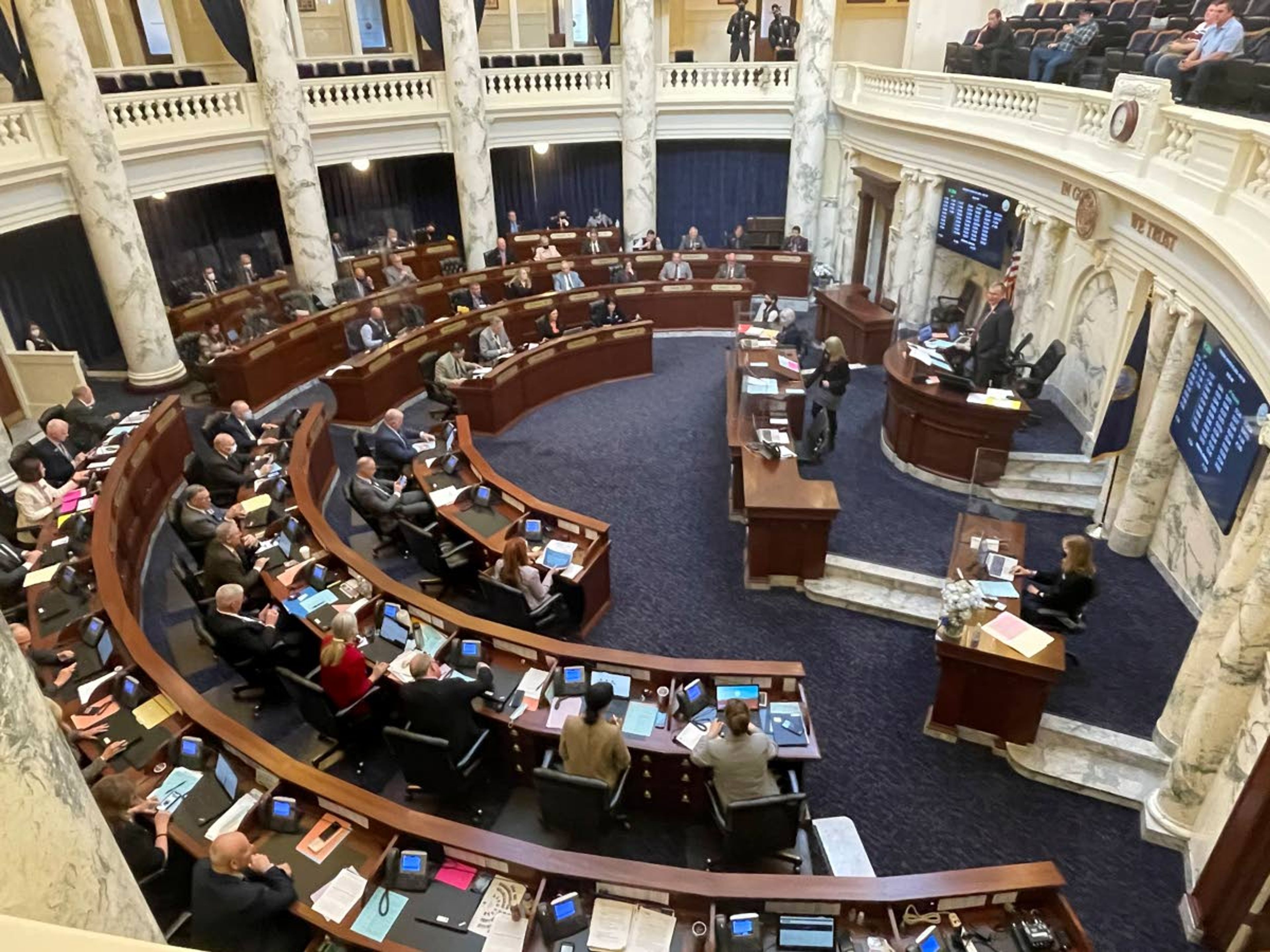 FILE - In this March 9, 2021, file photo, House members meet in the Statehouse, in Boise, Idaho. An Idaho law banning nearly all abortions would take effect if the U.S. Supreme Court overturns Roe v. Wade, the landmark 1973 ruling that declared a nationwide right to abortion. The court with a 6-3 conservative majority on Wednesday, Dec. 1 starts hearing arguments over a Mississippi law that bans abortions after 15 weeks. (AP Photo/Keith Ridler, File)