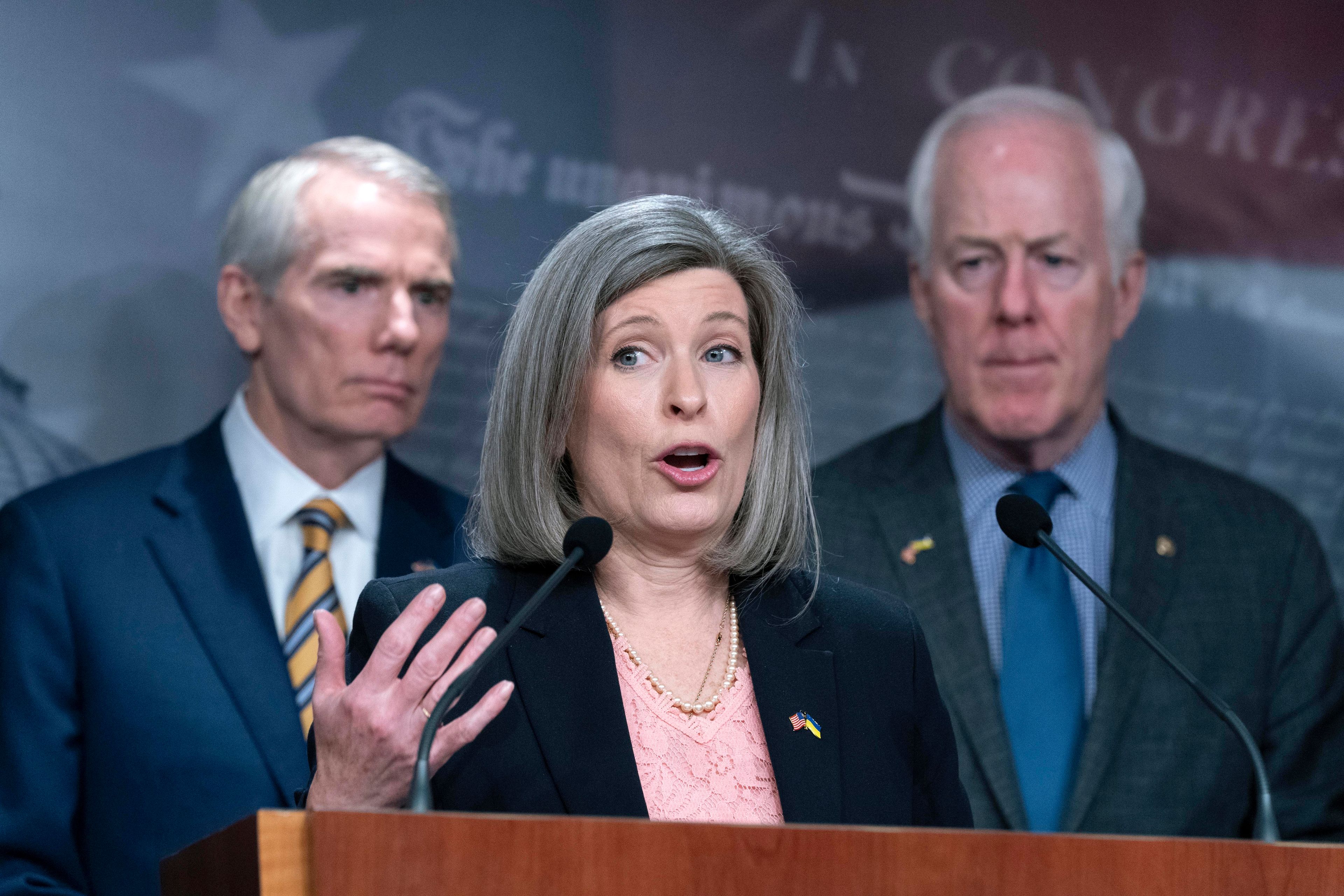 Sen. Joni Ernst, R-Iowa, flanked by Sen. Rob Portman, R-Ohio, and John Cornyn, R-Texas, speaks during a news conference about Ukraine on Capitol Hill in Washington, Wednesday, March 16, 2022. After Ukraine President Volodymyr Zelenskyy virtually addressed the U.S. Congress on Wednesday morning. ( AP Photo/Jose Luis Magana)