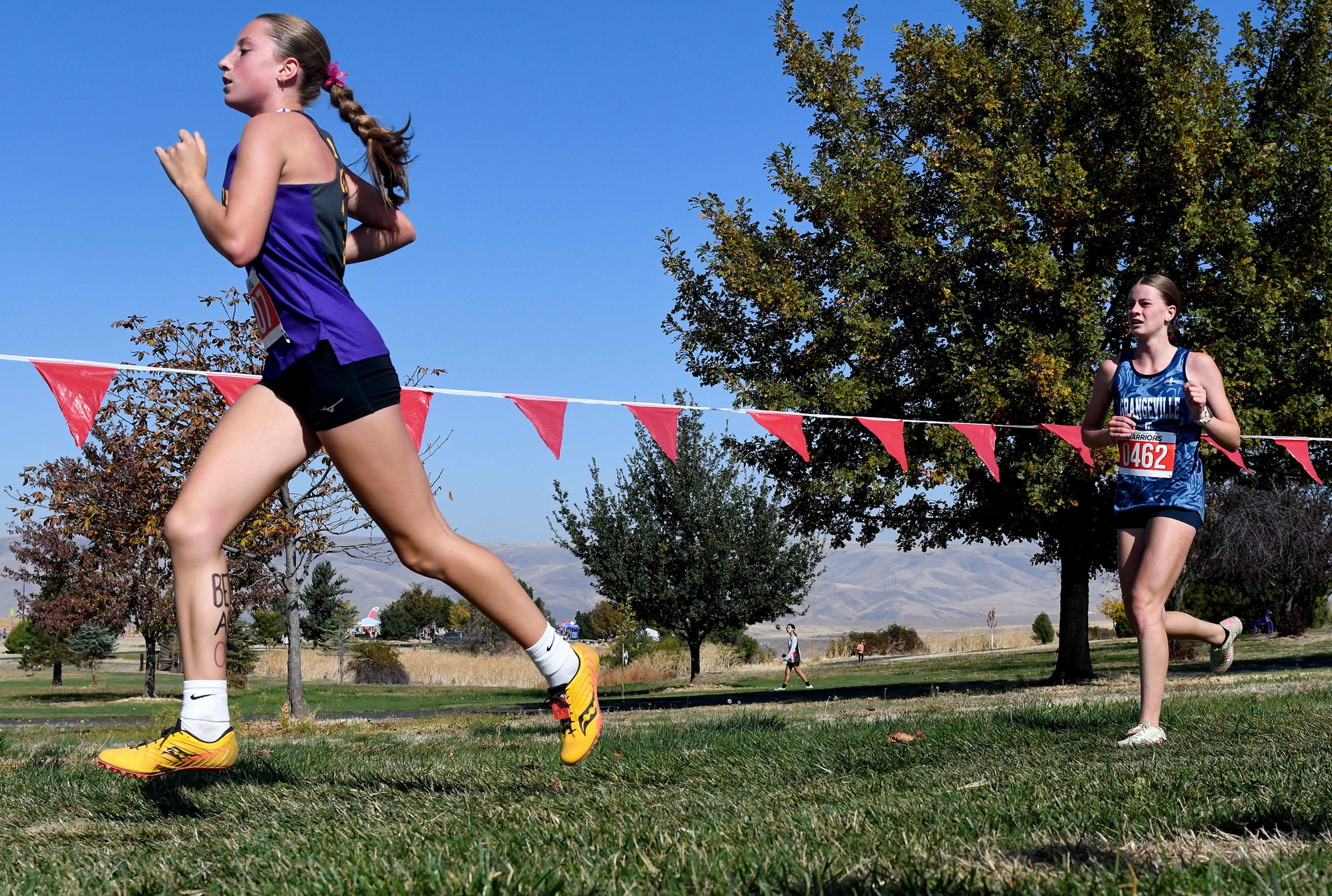 Lewiston's Lela Rehder and Grangeville's Callie Howe compete in the Inland Empire Championships varsity girls 5K Saturday along the LCSC XC Course in Lewiston.,