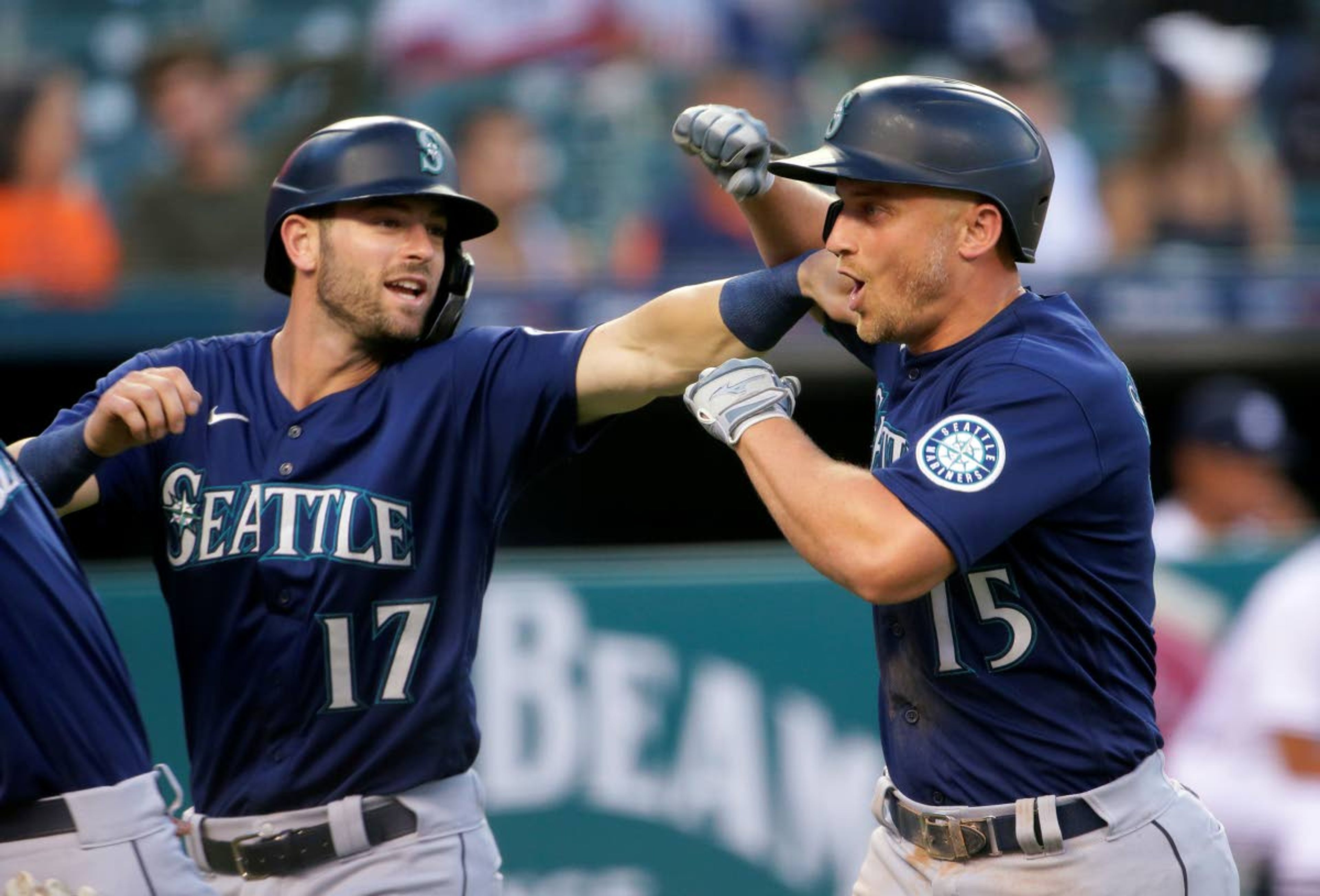 Seattle Mariners' Kyle Seager (15) celebrates with Mitch Haniger (17) after hitting a three-run home run against the Detroit Tigers during the sixth inning of a baseball game Wednesday, June 9, 2021, in Detroit. (AP Photo/Duane Burleson)