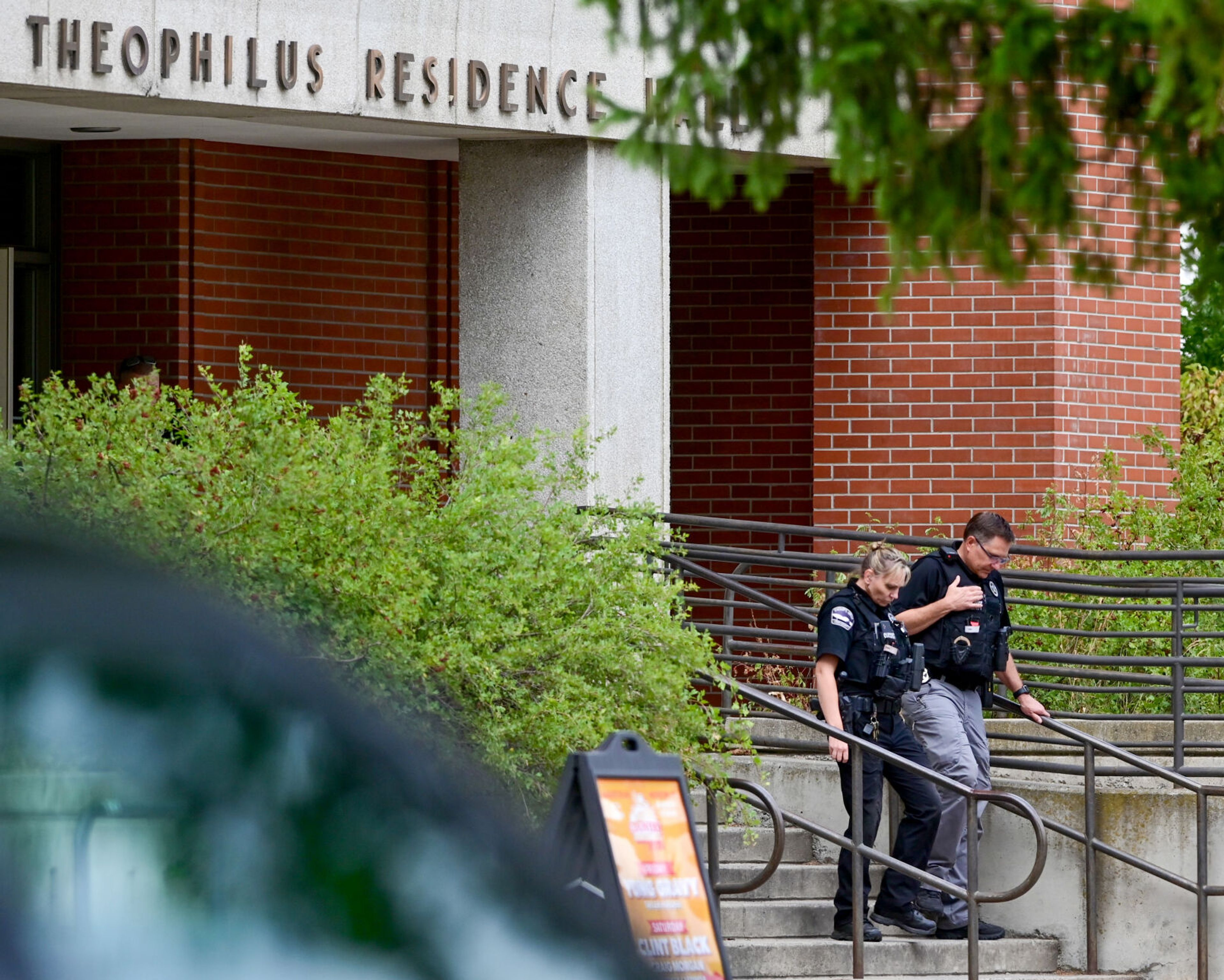 Police walk down the steps of Theophilus Tower on the University of Idaho campus on Tuesday in Moscow. Officers responded to reports that an inmate walked away from a cleaning crew in the dormitory that afternoon.