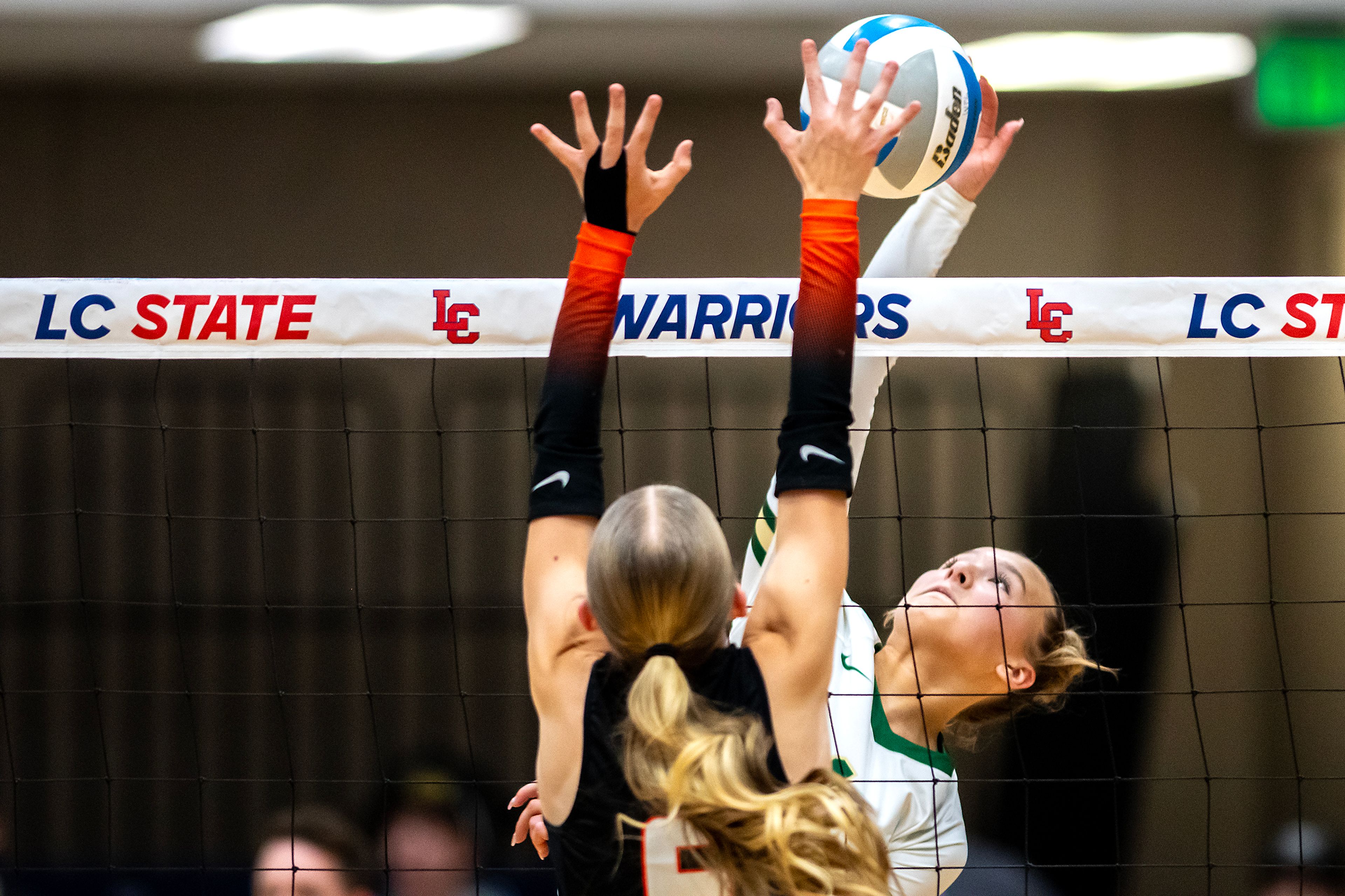 Potlatch outside hitter Aubree Lisher spikes the ball as Troy setter Ashlyn Strunk defends during a 2A district championship Wednesday at the P1FCU Activity Center in Lewiston.