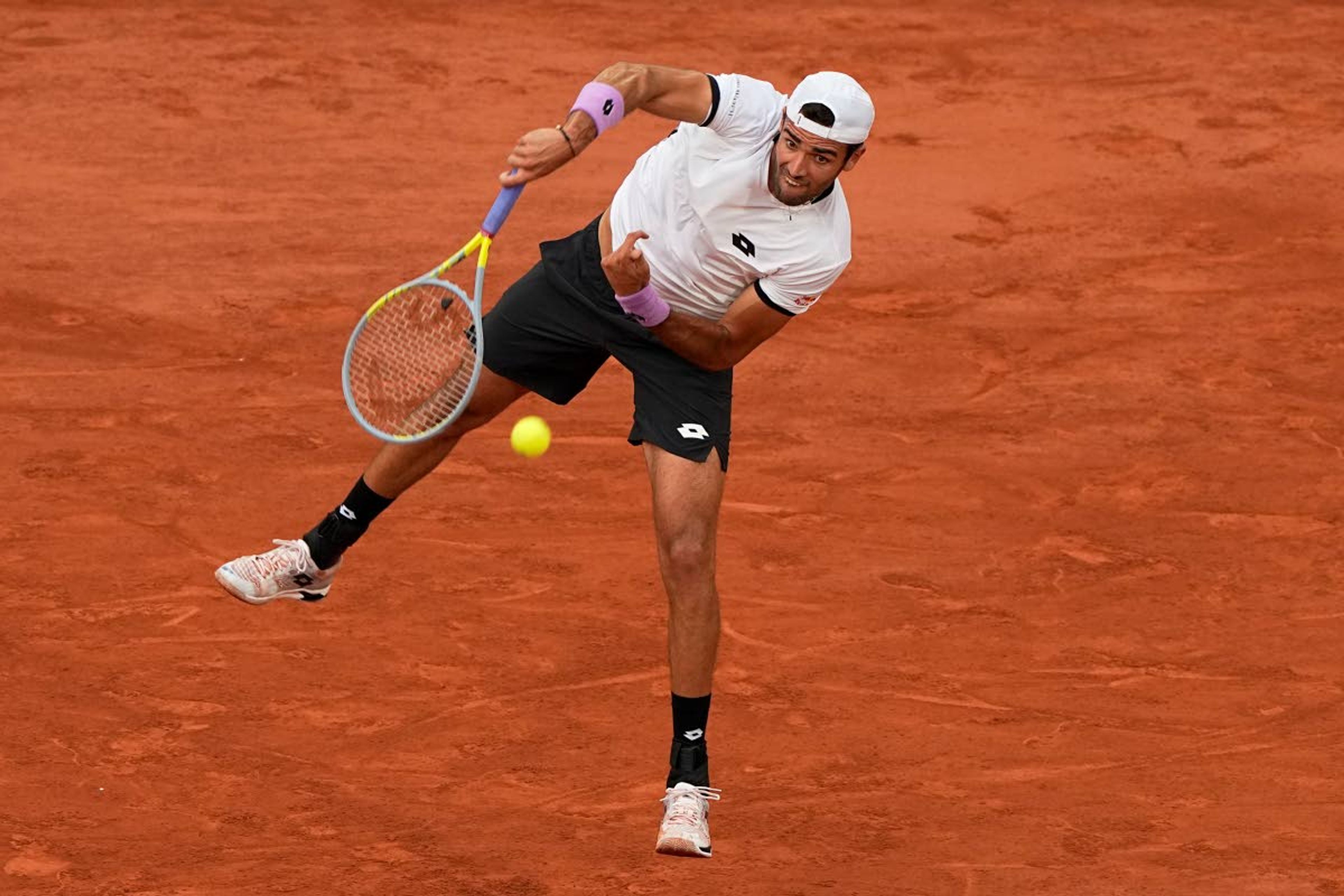 Italy's Matteo Berrettini serves the ball as he plays Serbia's Novak Djokovic during their quarterfinal match of the French Open tennis tournament at the Roland Garros stadium Wednesday, June 9, 2021 in Paris. (AP Photo/Michel Euler)