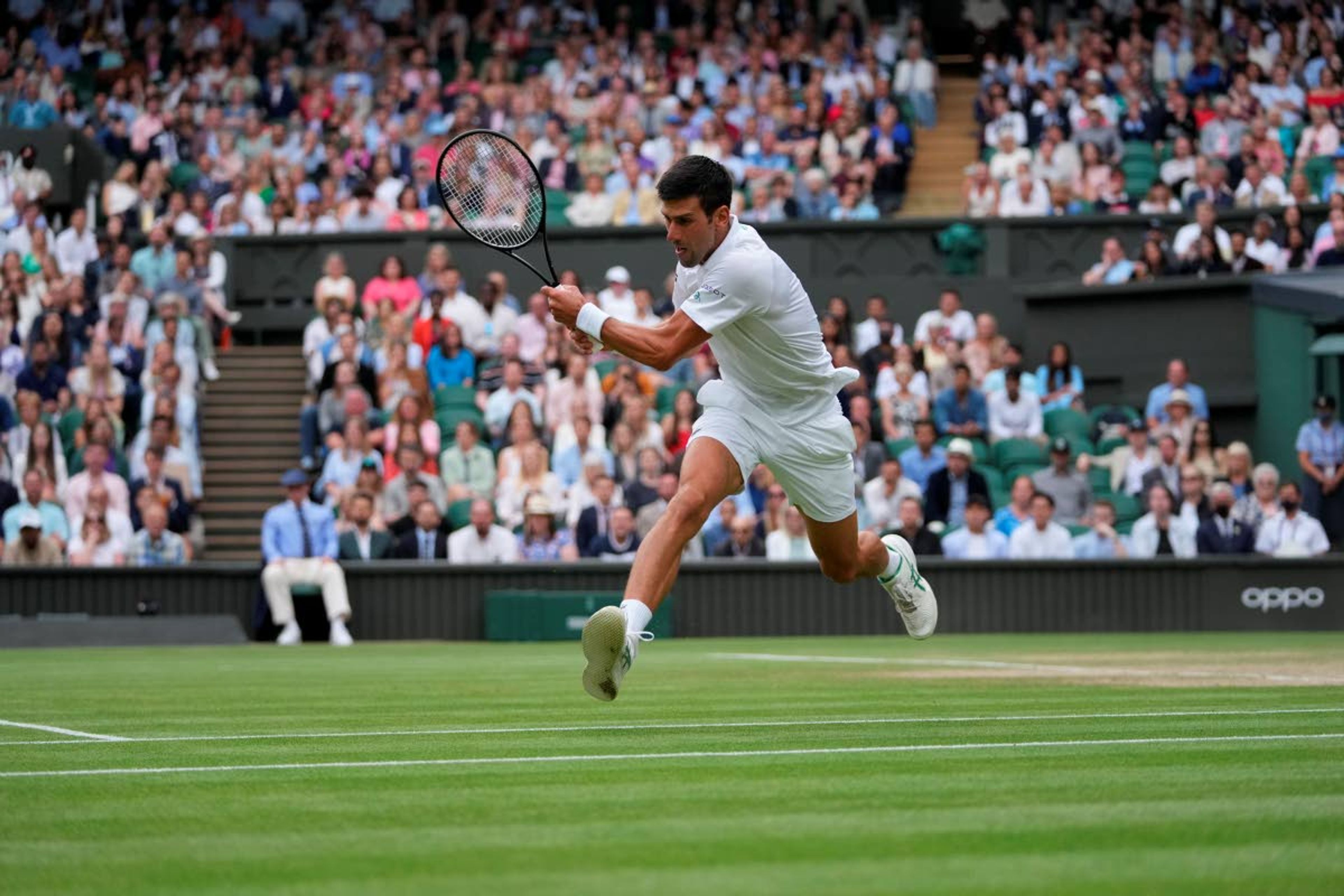 Serbia's Novak Djokovic plays a return to Canada's Denis Shapovalov during the men's singles semifinals match on day eleven of the Wimbledon Tennis Championships in London, Friday, July 9, 2021. (AP Photo/Alberto Pezzali)