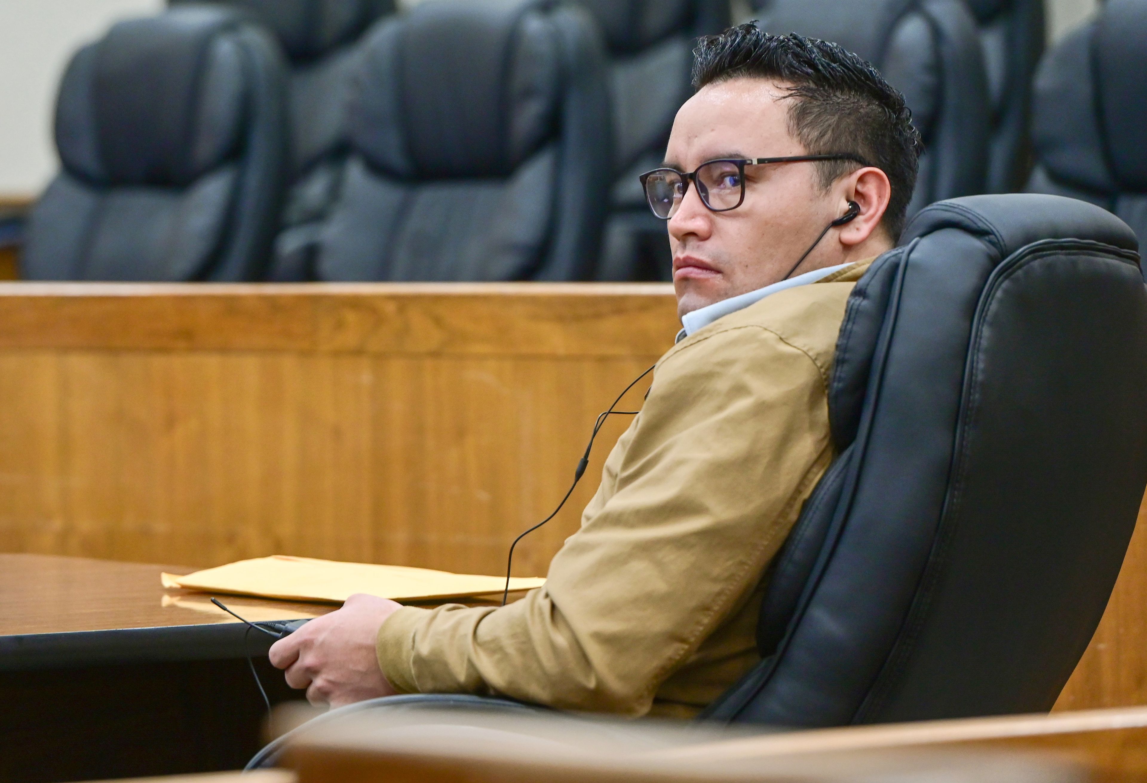 Juan Trejo Perez sits in a Whitman County Superior Court room in Colfax on Tuesday with ear buds in to hear translators. A jury will choose whether to convict the 34-year-old Trejo Perez of felony third-degree child molestation.