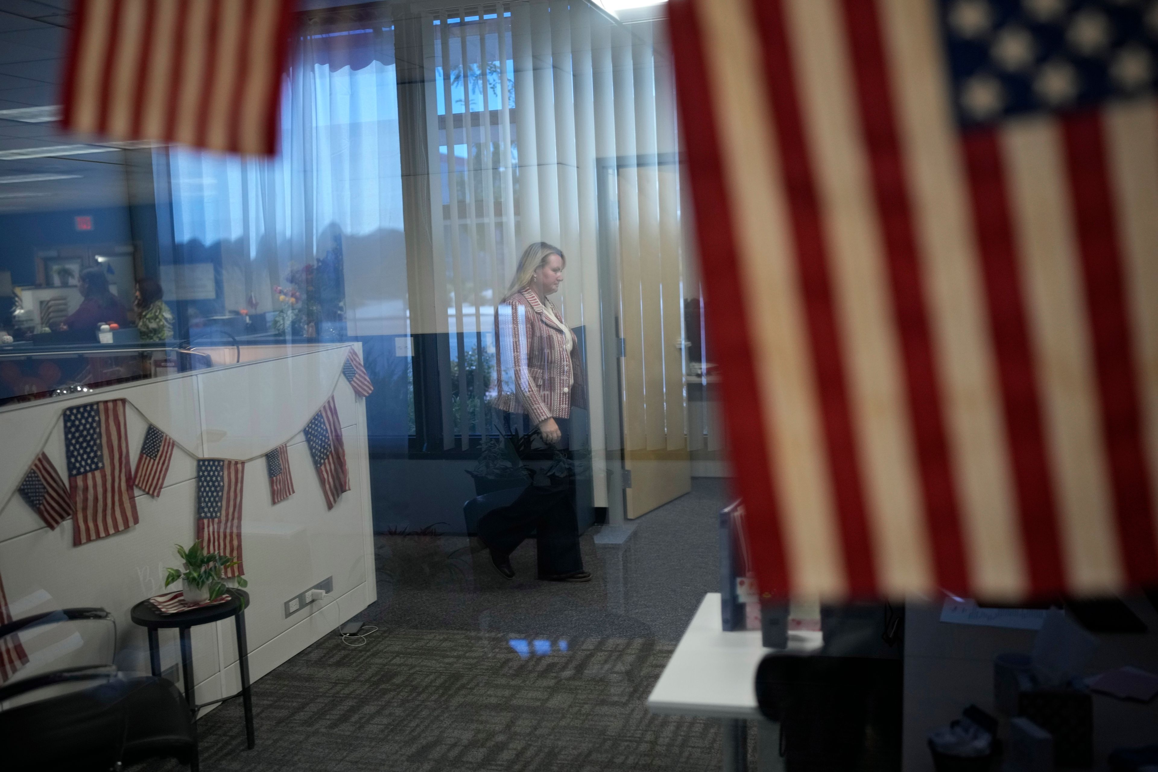 Cari-Ann Burgess, interim Registrar of Voters for Washoe County, Nev., walks through the office, Friday, Sept. 20, 2024, in Reno, Nev. (AP Photo/John Locher)