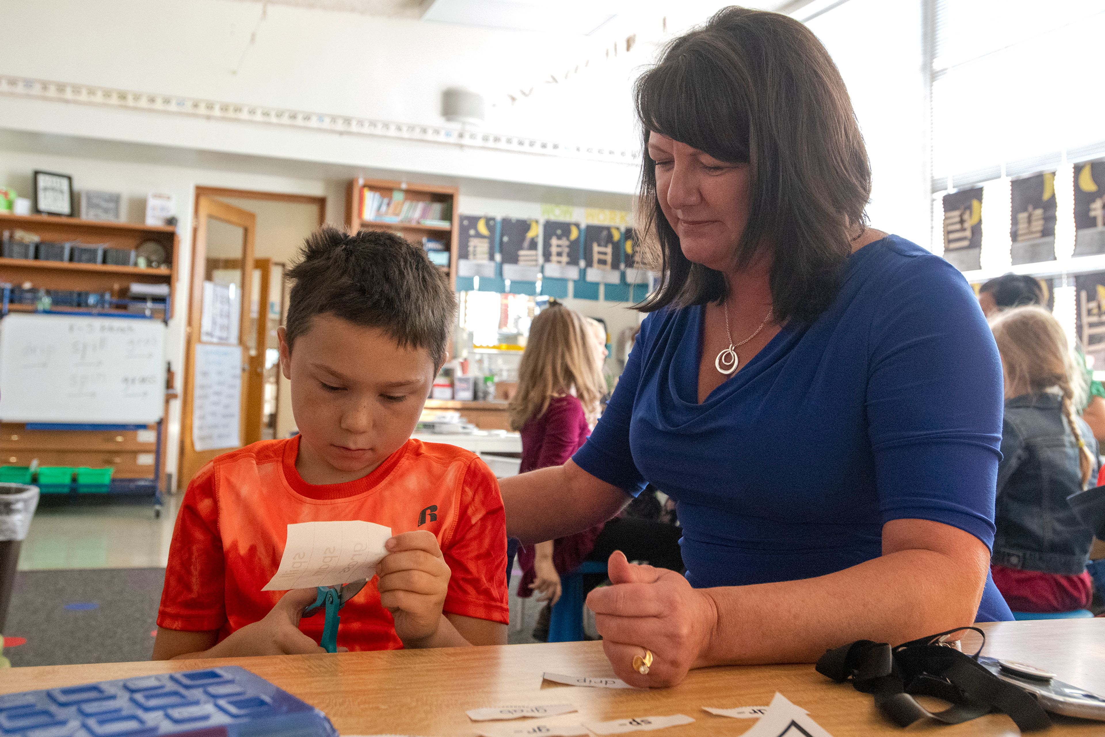 McMillan assists a first-grade student at Lena Whitmore Elementary School in Moscow.