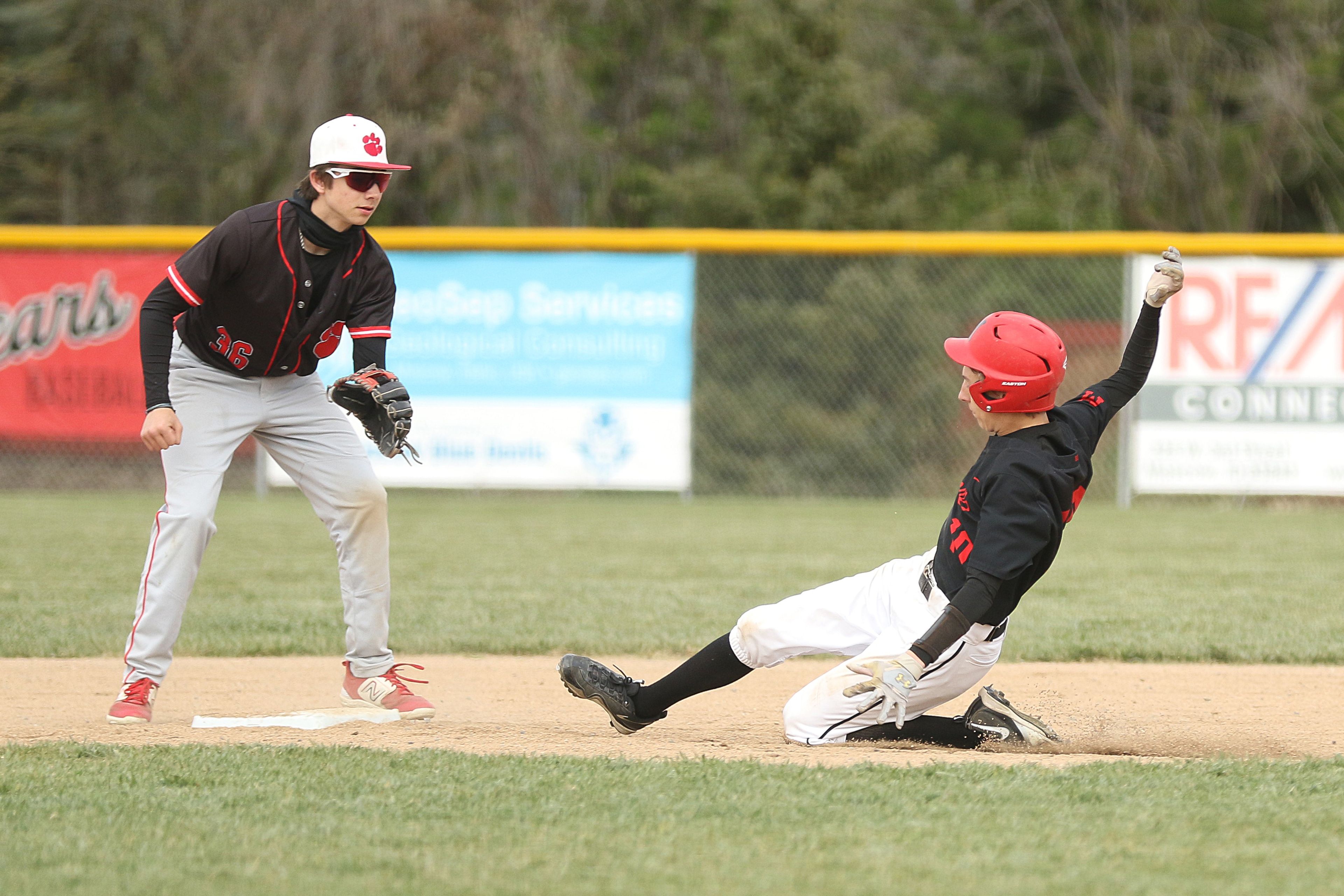 Moscow's Simeon Rauch (right) steals second base during an Idaho Class 4A district championship game against Sandpoint on Wednesday in Moscow.