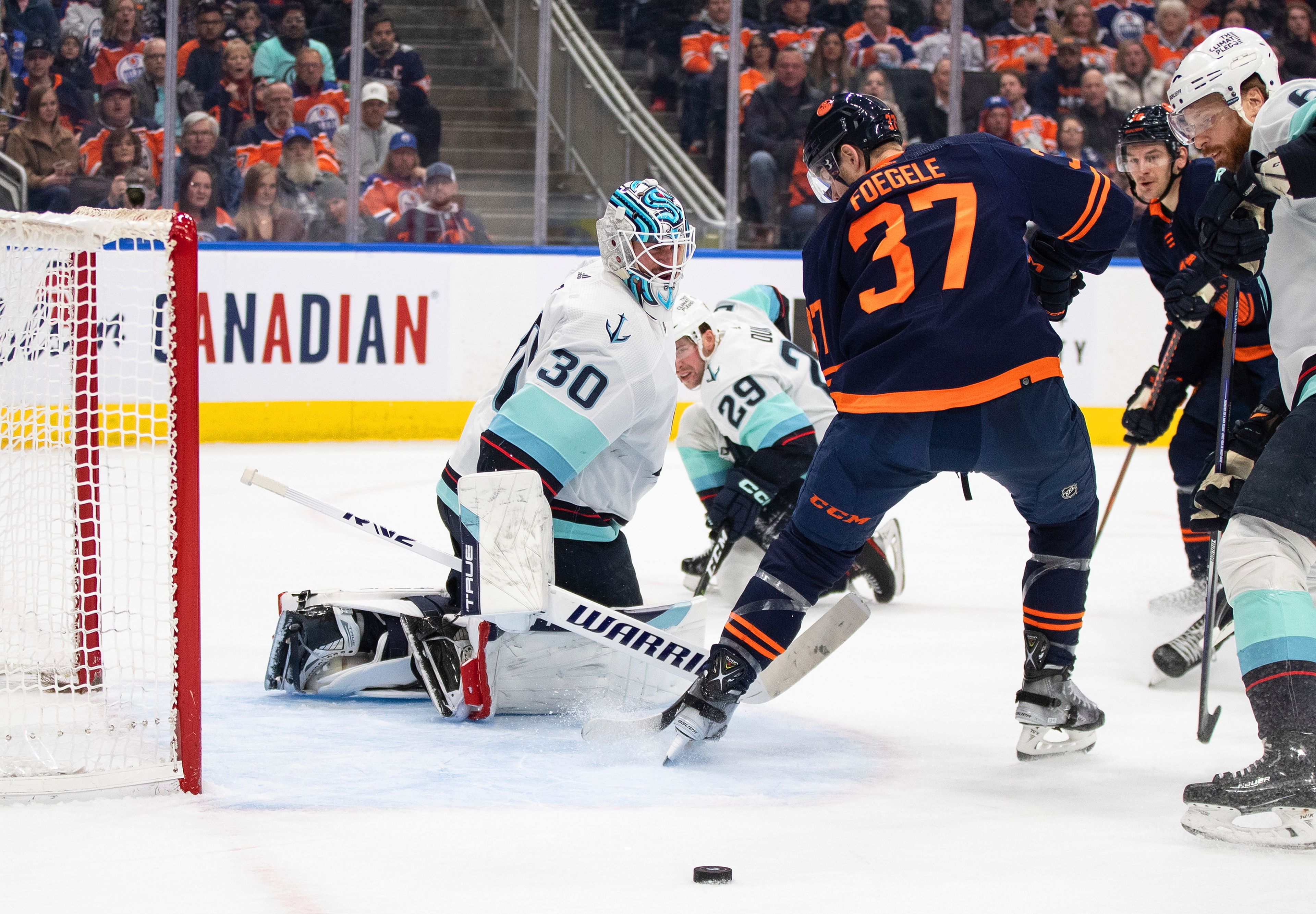 Seattle Kraken goalie Martin Jones (30) makes a save on Edmonton Oilers' Warren Foegele (37) during the second period of an NHL hockey game Tuesday, Jan. 17, 2023, in Edmonton, Alberta. (Jason Franson/The Canadian Press via AP)