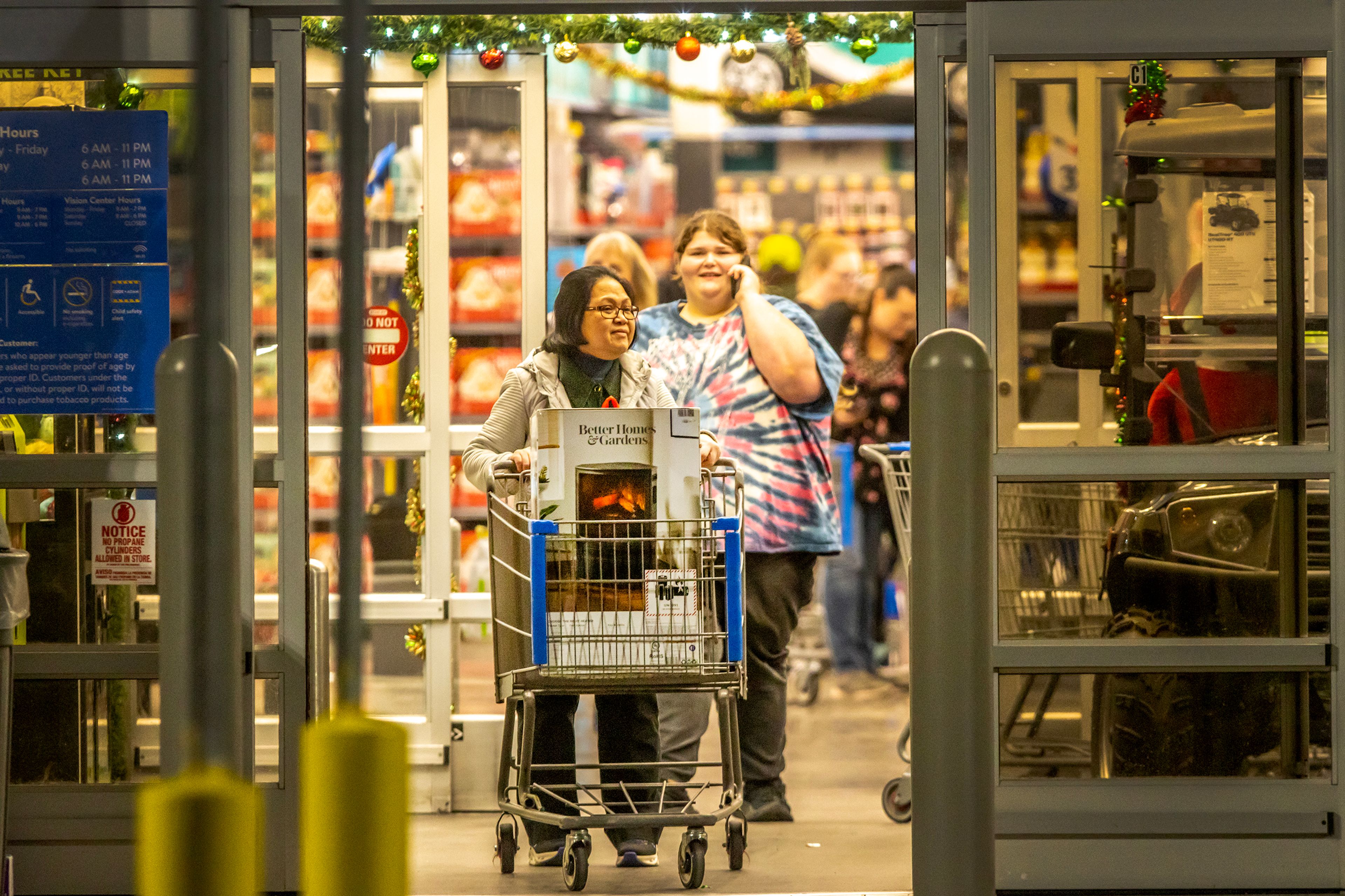 A person leaves Walmart with a heater Wednesday in Clarkston. A gas outage caused by a line rupture north of Pullman lead to a run on heaters at area businesses, with Costco running out of portable heaters.