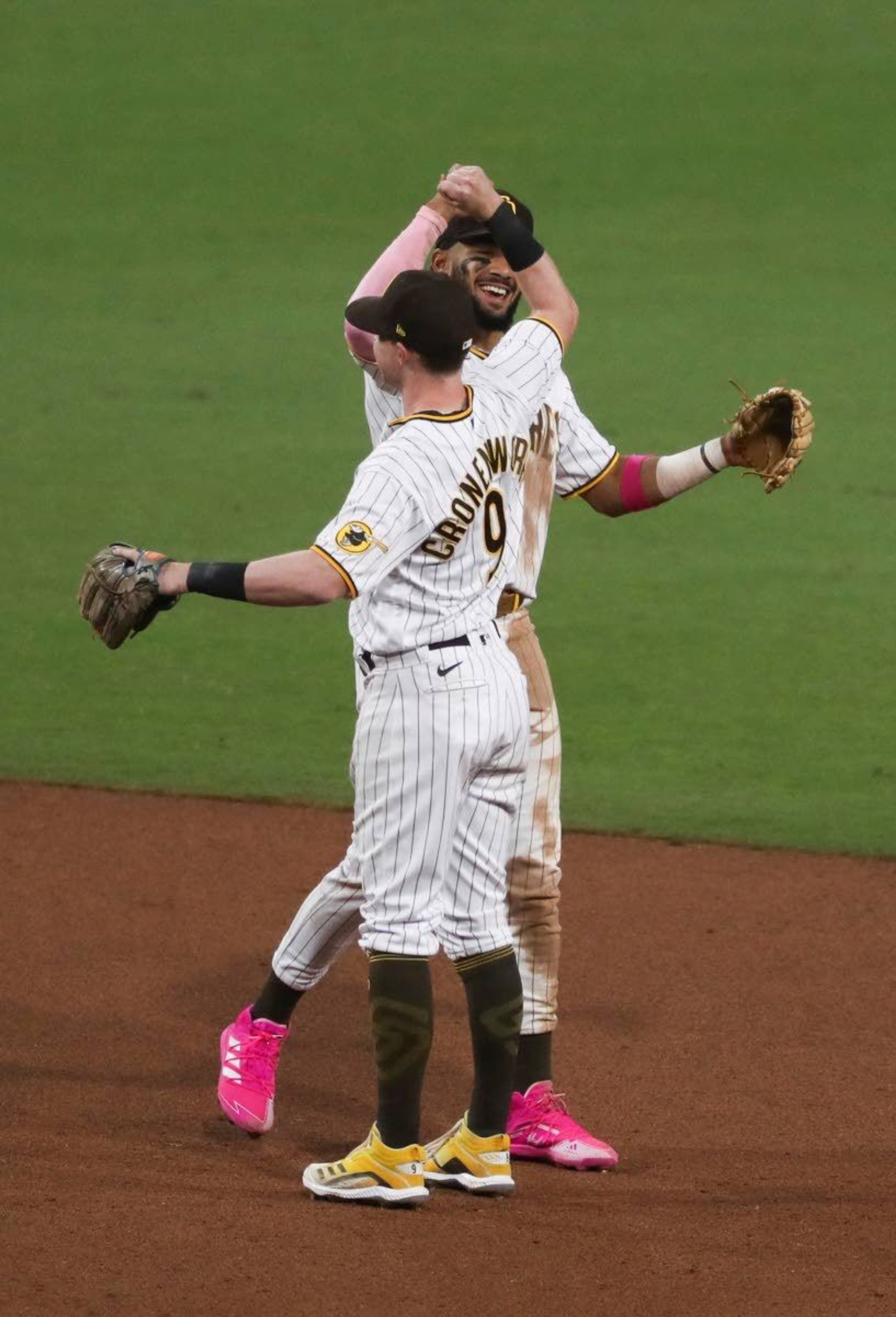 San Diego Padres shortstop Fernando Tatis Jr., rear, and second baseman Jake Cronenworth (9) celebrate after the Padres defeated the Seattle Mariners 6-4 in a baseball game Saturday, May 22, 2021, in San Diego. (AP Photo/Derrick Tuskan)