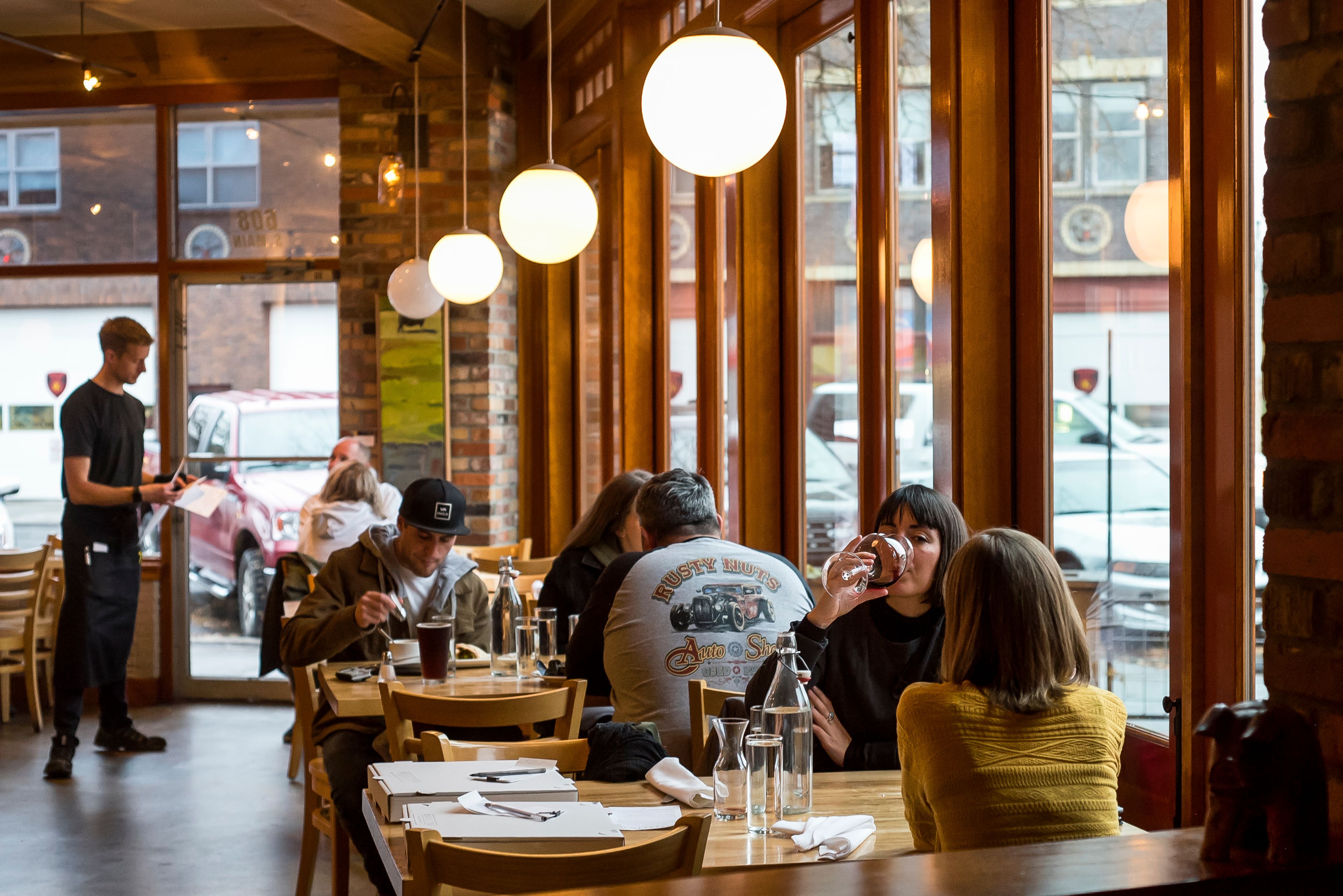 People enjoy their meals at Maialina Pizzeria Napoletana beside windows looking out at Main Street on Nov. 15 in Moscow.