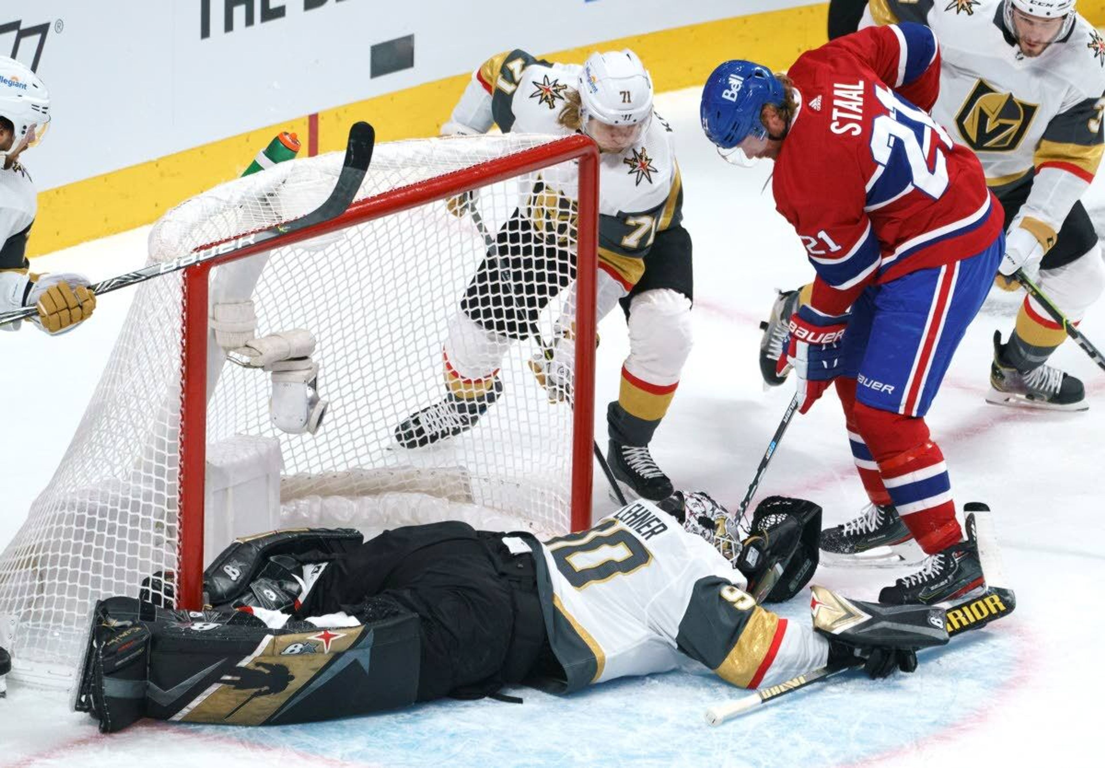 Montreal Canadiens' Eric Staal tries to poke the puck away from Vegas Golden Knights goaltender Robin Lehner as Golden Knights' William Karlsson covers during first-period Game 4 NHL Stanley Cup playoff hockey semifinal action in Montreal, Sunday, June 20, 2021.