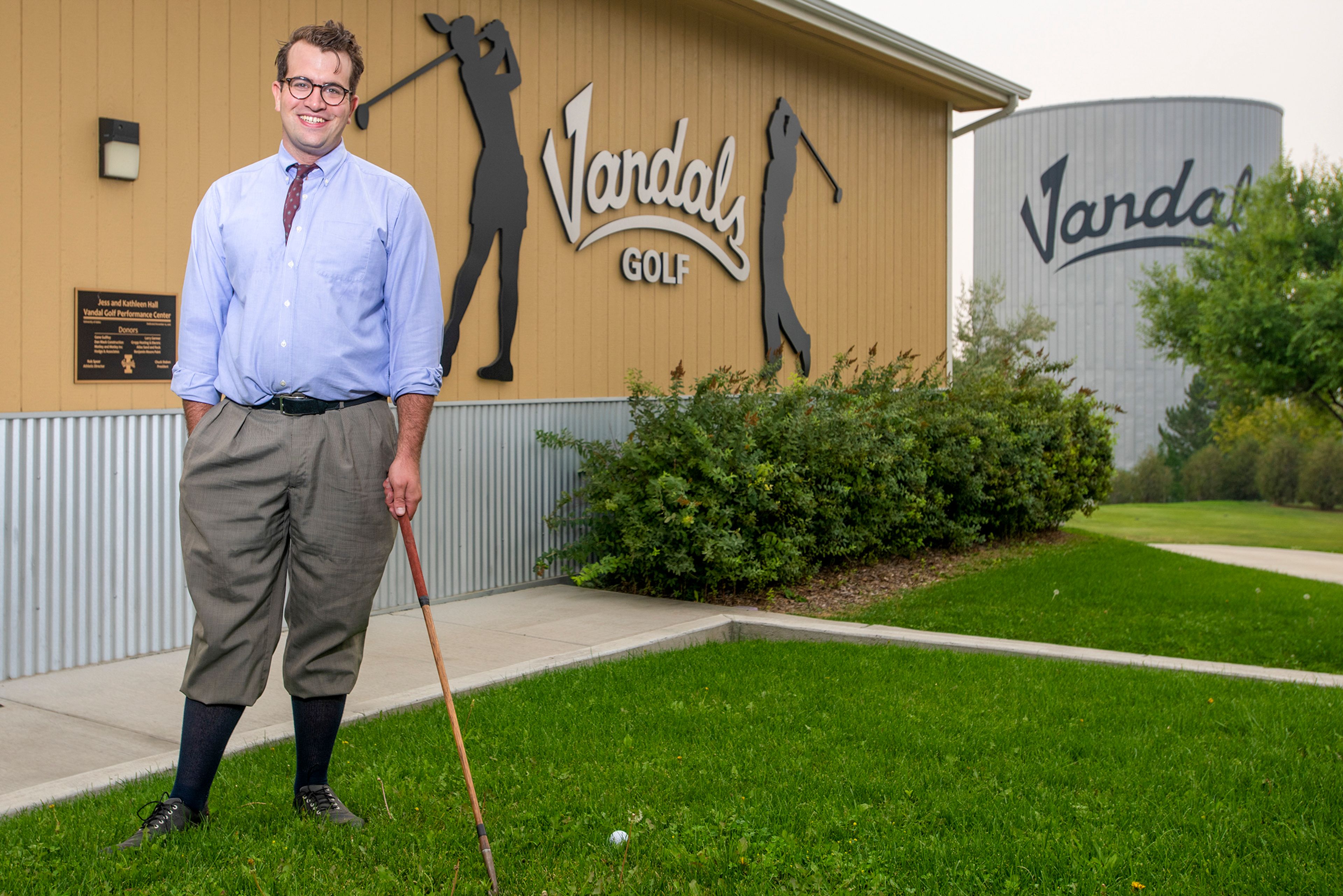 Colin Criss McNamara poses at the University of Idaho Golf Course while wearing golf attire worn by players in the hickory era of the game from the 1850s to the mid-1930s.