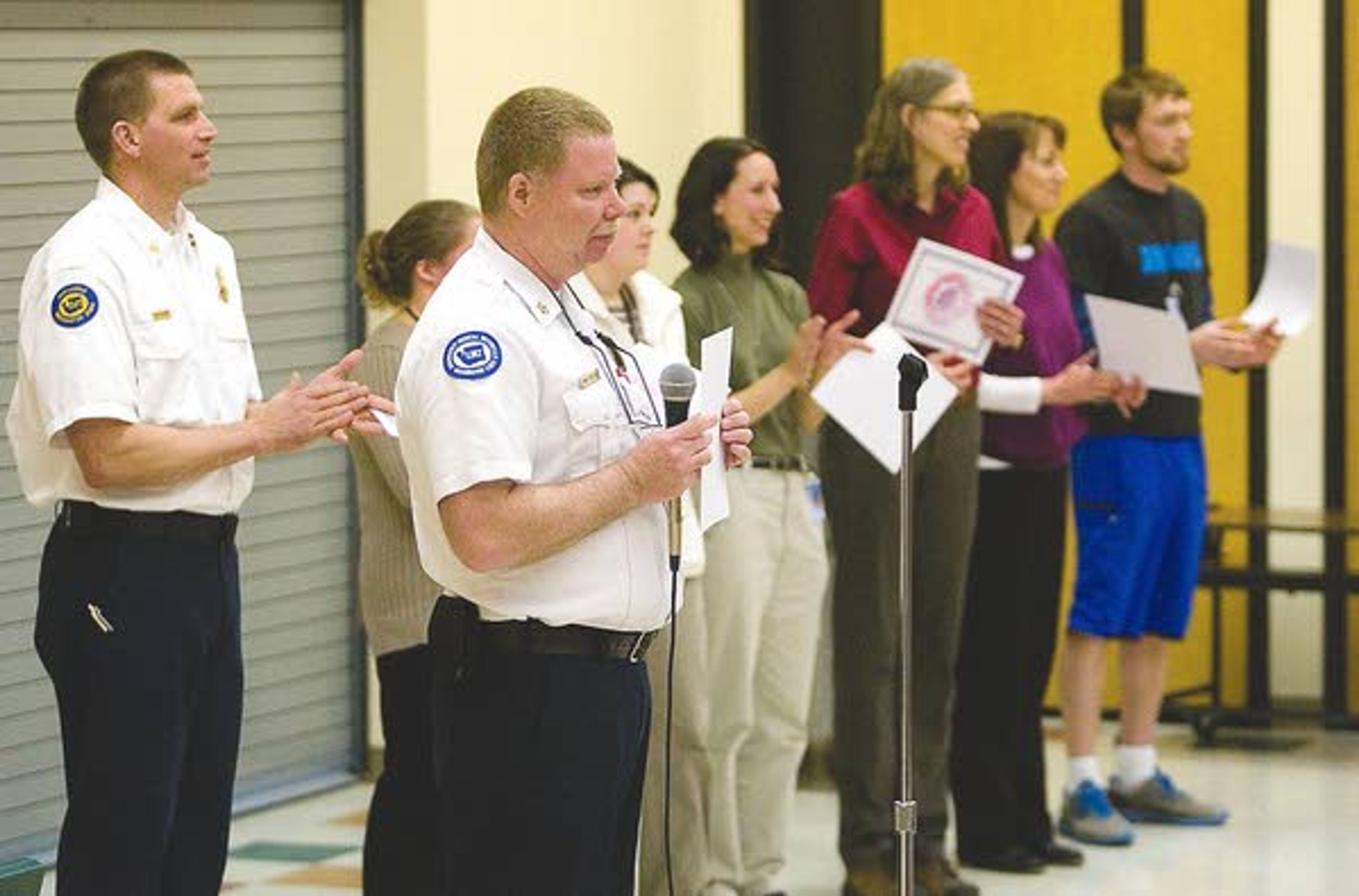 Pullman Fire Chief Mike Heston, center, presents civilian lifesaving awards to employees of Franklin Elementary School on Tuesday. The employees treated special education paraprofessional after she had a heart attack on Dec. 17.