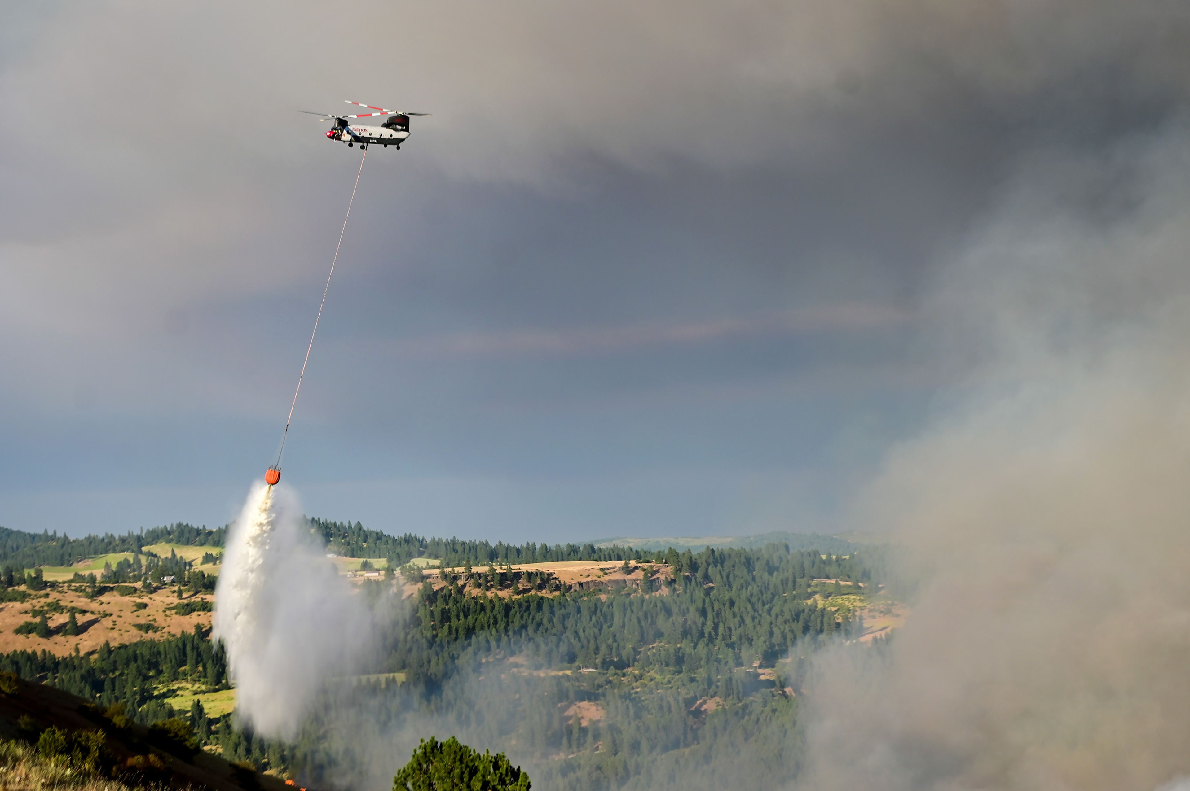 Fire retardant is dumped on the wildfire in the area of Texas Ridge and Cedar Ridge roads near Kendrick on Monday.