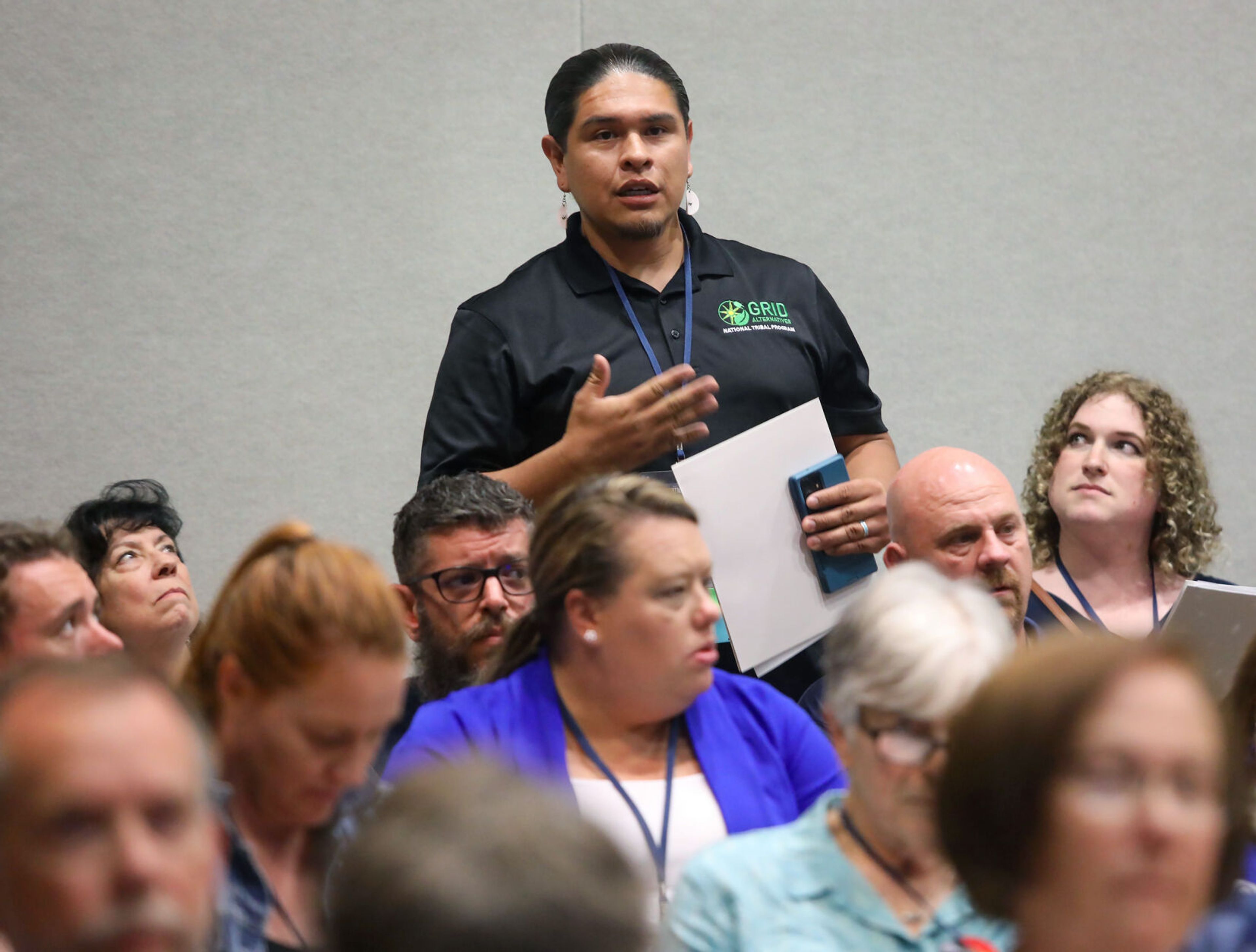 Dayne Goodheart, a Grid Alternatives manager and trainer from Nez Perce County, stands to give feedback during the Platform Hearing at the Idaho Democratic Convention on Saturday in Moscow. Lily Pannkuk, a delegate from Ada County, listens from Goodheart’s right side.